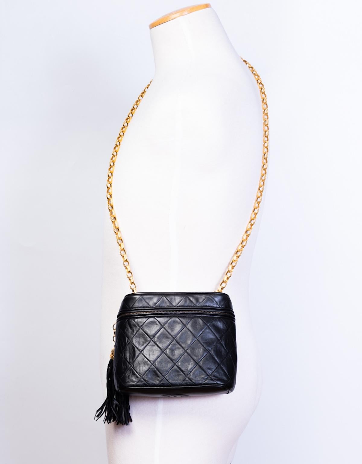 This vintage Chanel mini vanity is constructed in black diamond quilted leather with gold toned hardware, a zipper closure with a tassel, and a gold toned chain strap. The interior is lined in a cream fabric with a zipper pocket. s with the. Seven
