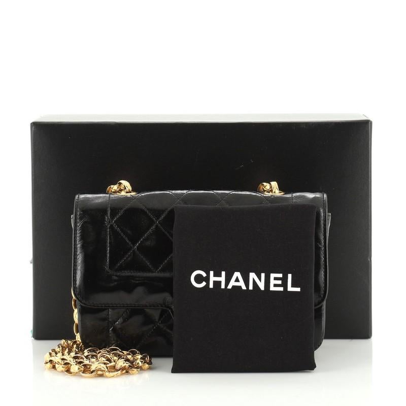 This Chanel Vintage Diana Flap Bag Quilted Patent Mini, crafted in black quilted patent leather, features woven in leather chain link strap and gold-tone hardware. Its CC turn-lock closure opens to a red leather interior with zip and slip pockets.