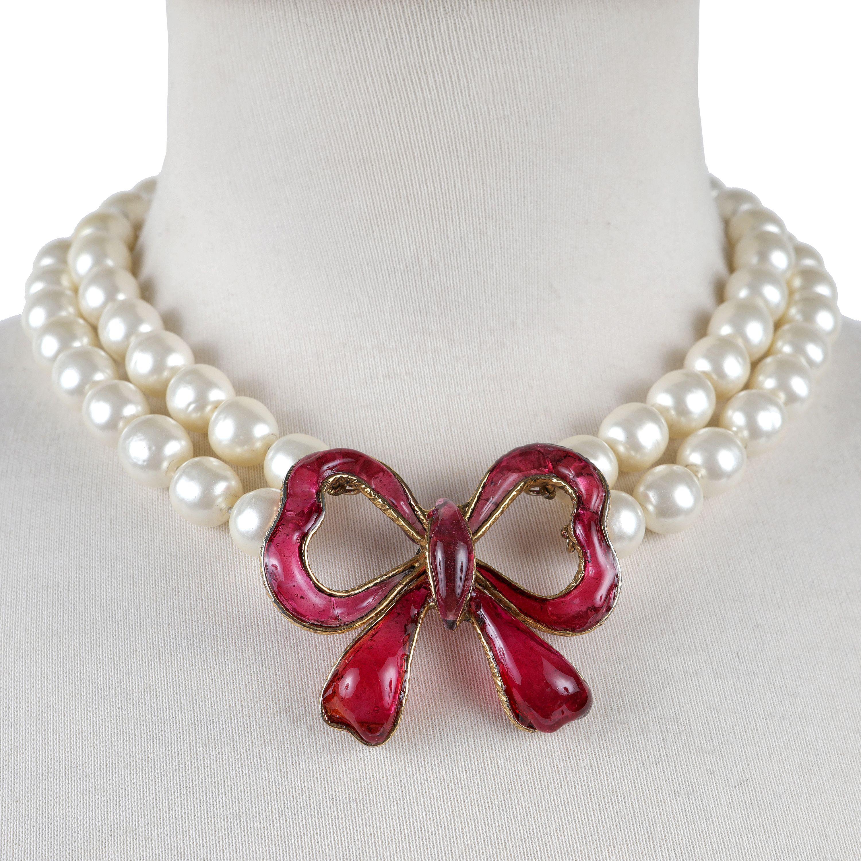 This authentic Chanel Double Pearl Red Gripoix Bow Choker is in excellent vintage condition from the 1970’s.  Double strand of large faux pearls is anchored with a substantial red bow made in Gripoix glass.   Pouch or box included.

PBF 13802
