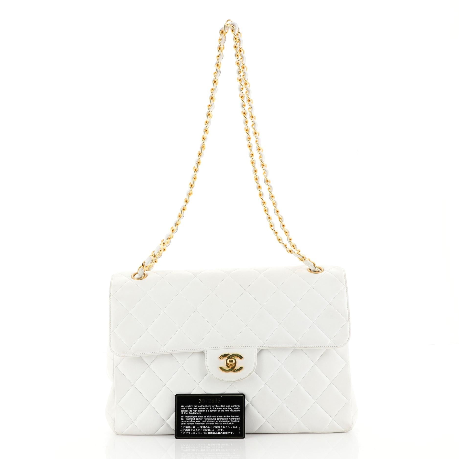 This Chanel Vintage Double Sided Flap Bag Quilted Lambskin Jumbo, crafted in white quilted lambskin leather, features woven-in leather chain strap, frontal flap on each side, and gold-tone hardware. Its CC turn-lock closure opens to a white leather