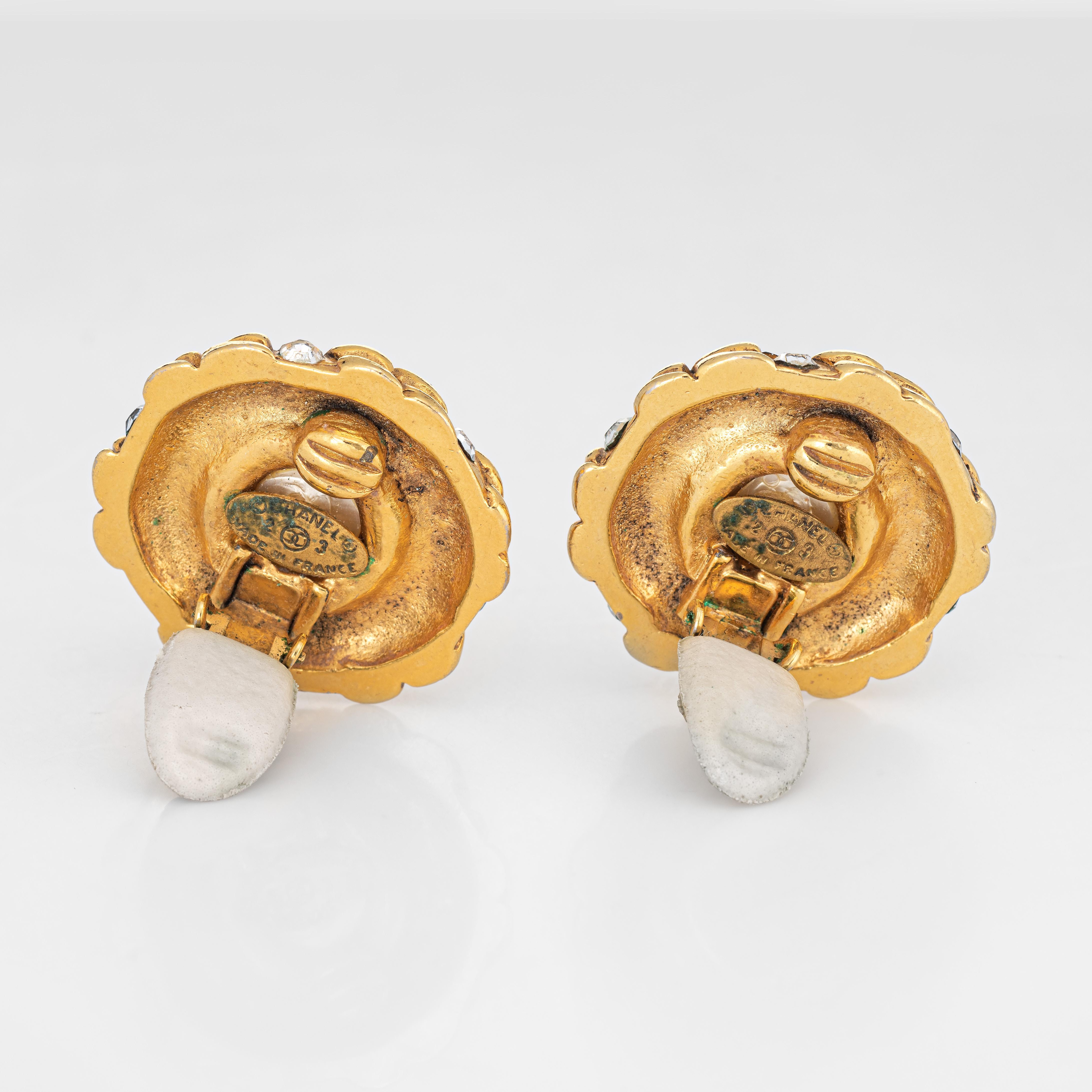 Vintage Chanel clip on earrings crafted in yellow gold tone (circa mid-1980s). 

The earrings are set with faux pearls to the center (16mm) accented with white crystals. The crystals are in-tact in good condition. The earrings date to the mid-1980s