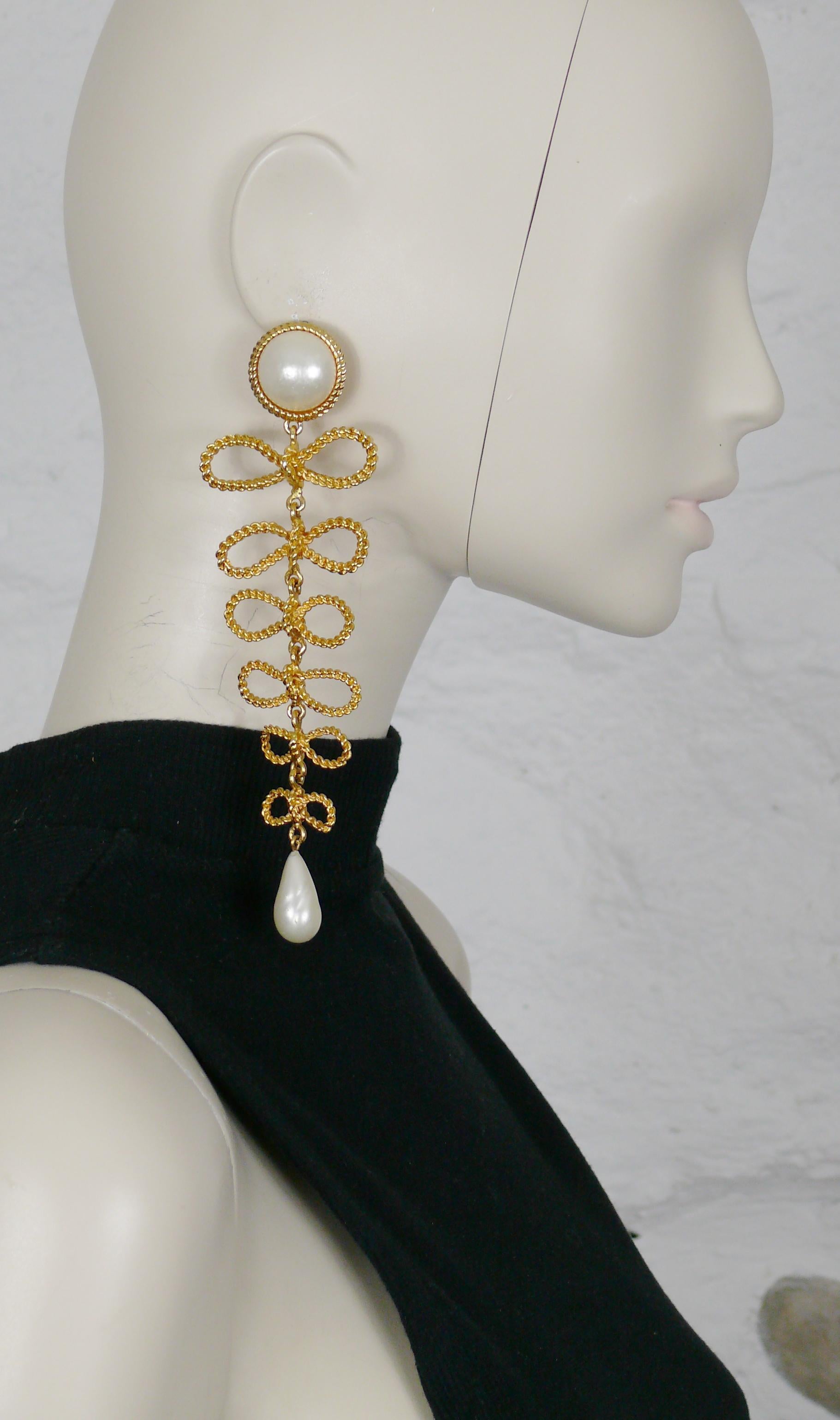 CHANEL vintage rare extra long dangling earrings (clip-on) featuring 6 graduated braided rope bows embellished with glass faux pearls.

Embossed CHANEL.
Private sale 