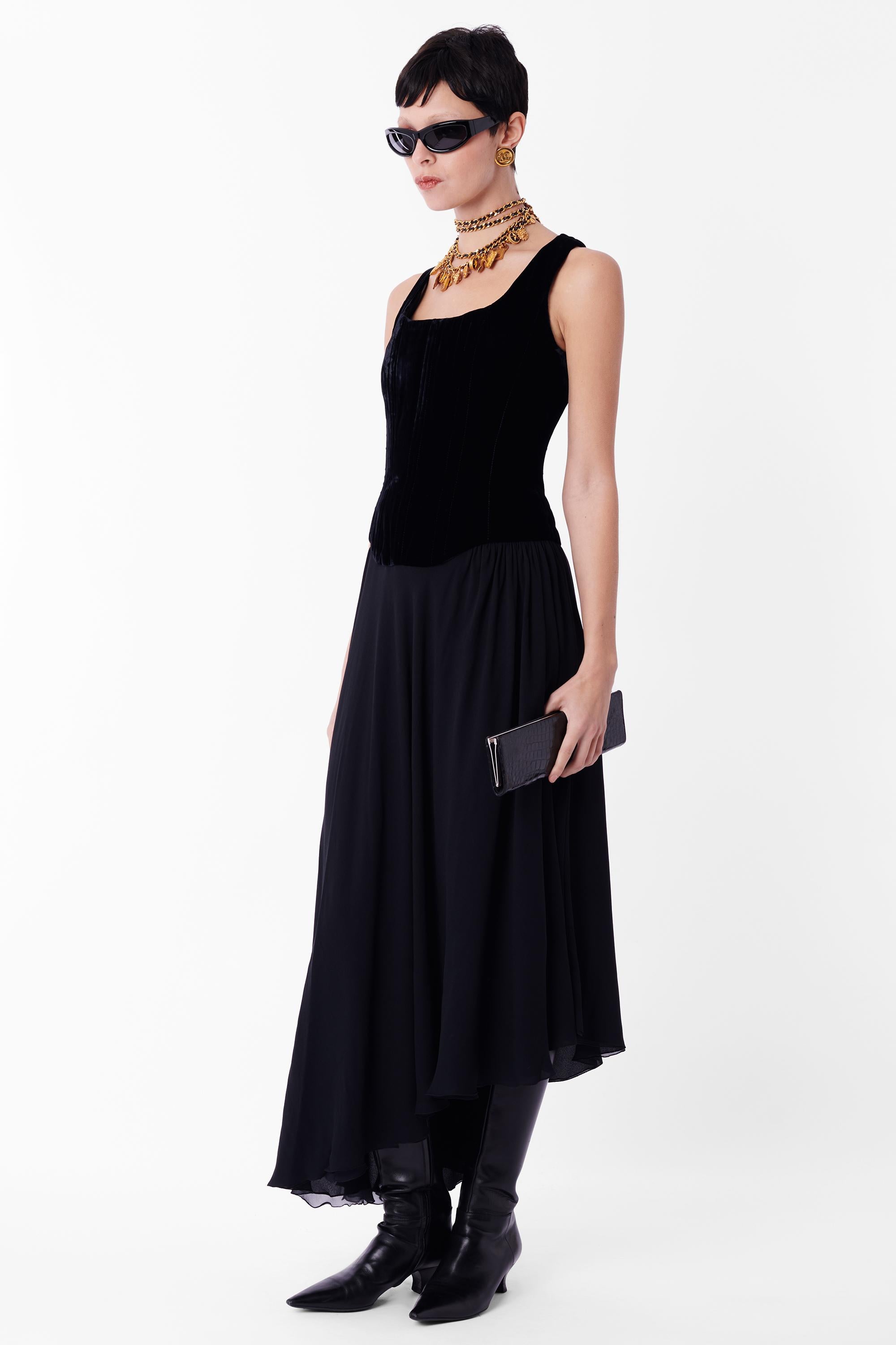 Vintage Chanel by Karl Lagerfeld boned corset dress. As seen on the runway, as modelled by Estelle Lefebure. Features velvet upper, covering the ‘corset’ of the dress where boning covers the front and back, thick straps, rounded scoop neck and