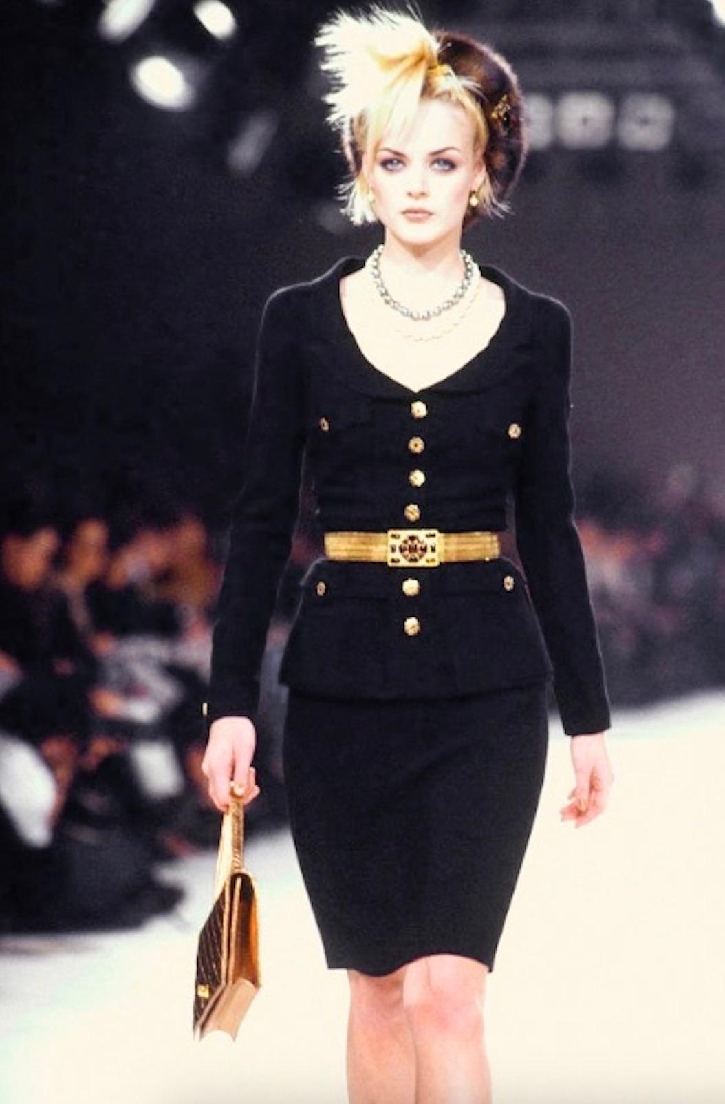 A timeless and highly collectible piece from Chanel’s Fall/Winter 1996 collection, this tailored black wool jacket embodies Karl Lagerfeld’s refined vision of the maison during the 1990s. Structured with a nipped-in waist and strong shoulders, it