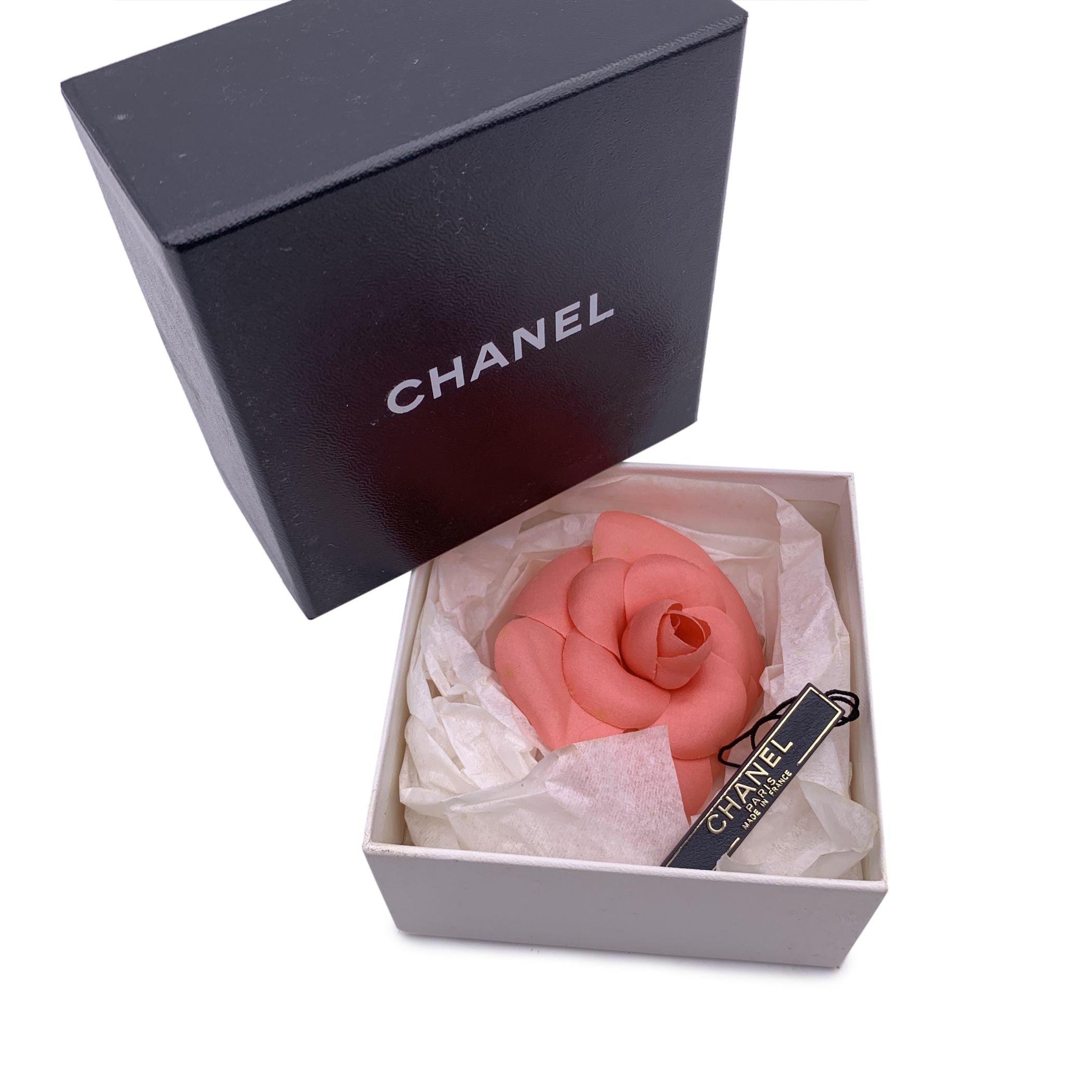 Chanel Vintage Camelia Camellia Flower Pin Brooch. Pink fabric petals. Safety pin closure. Measurements: diameter:3 inches - 7.6 cm. 'CHANEL - CC - Made in France' oval tab on the back Condition A - EXCELLENT Gently used. Please check the photos