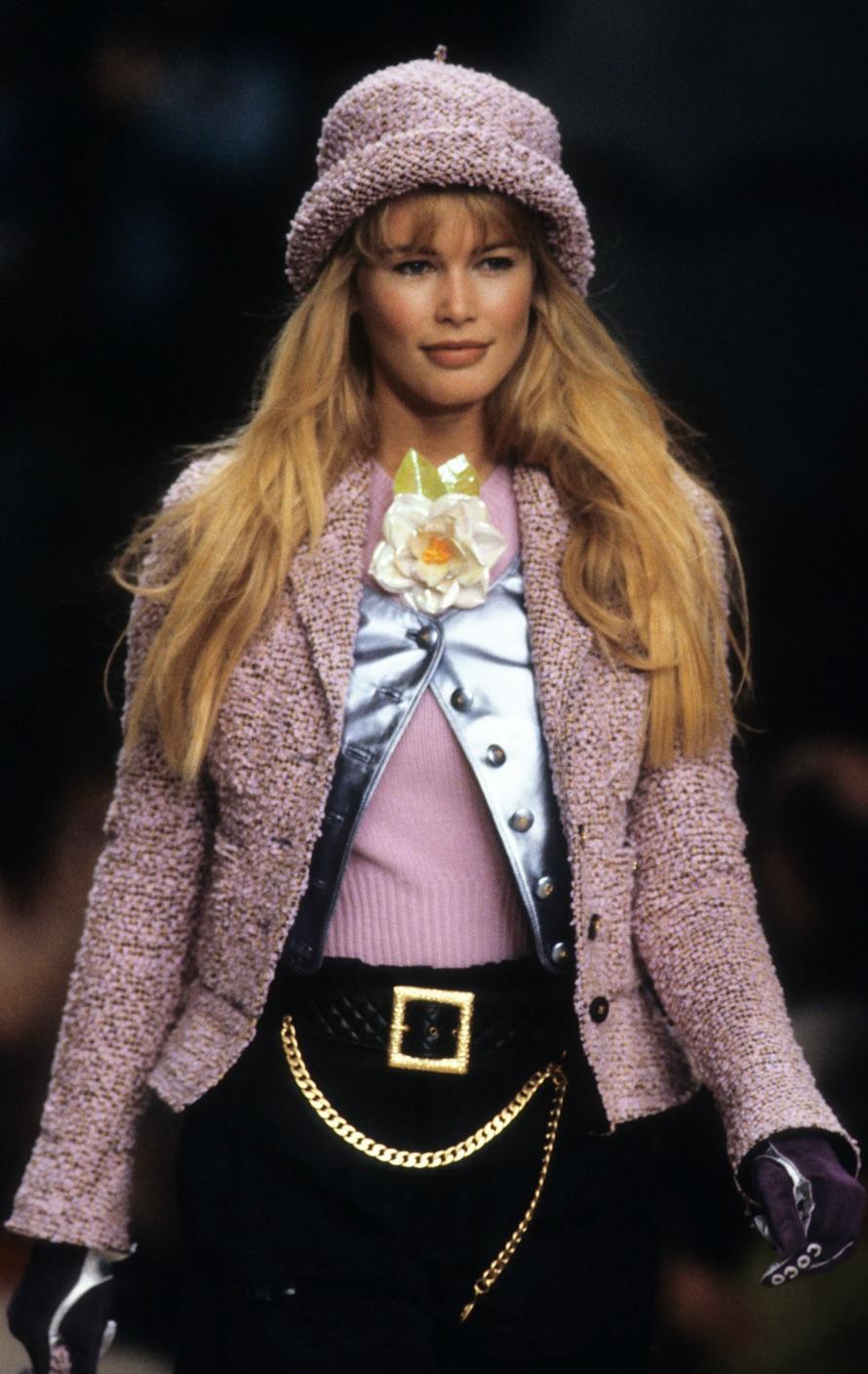 This iconic Chanel suit is a vintage piece from the Fall Winter 1994 collection. As seen on Claudia Schiffer. Expertly crafted in France from delicate lilac purple, orange and black fantasy tweed, this single-breasted design features a curved