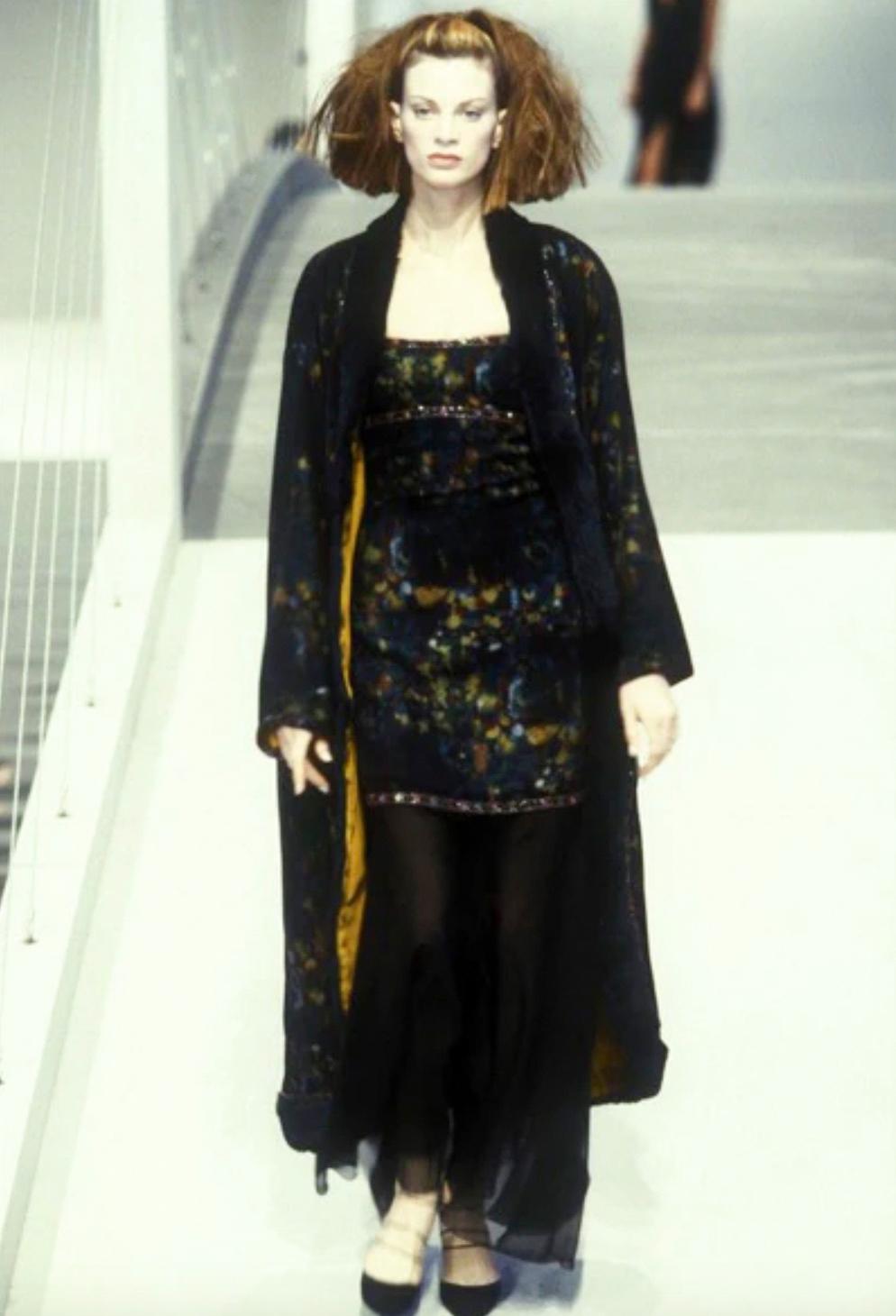 This exquisite watercolor beaded gown by Karl Lagerfeld for Chanel's Fall/Winter 1997 collection, modeled by Kristen McMenamy, is a real masterpiece.  The gown showcases a delicate beaded trim around the bustline and straps, complemented by a