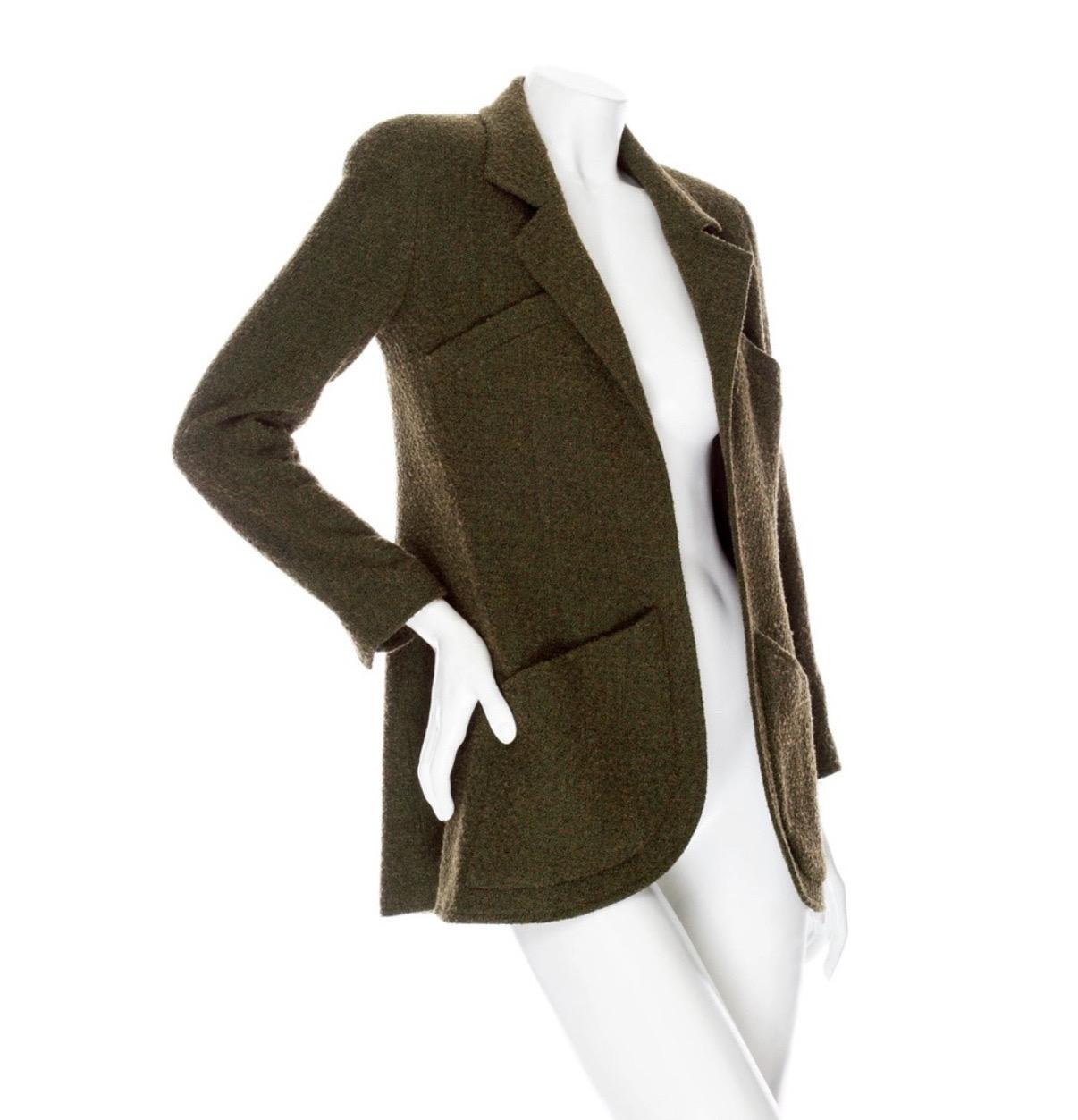 Chanel 1994 Green Tweed CC Button Jacket

Fall 1994 Collection for Chanel Boutiques
Olive Green / Brown
Tweed
Long sleeve
Gold-tone CC button cuffs
Notch lapels
Top slant pockets and lower patch pockets
Curved hem
Open front
Signature chain trim