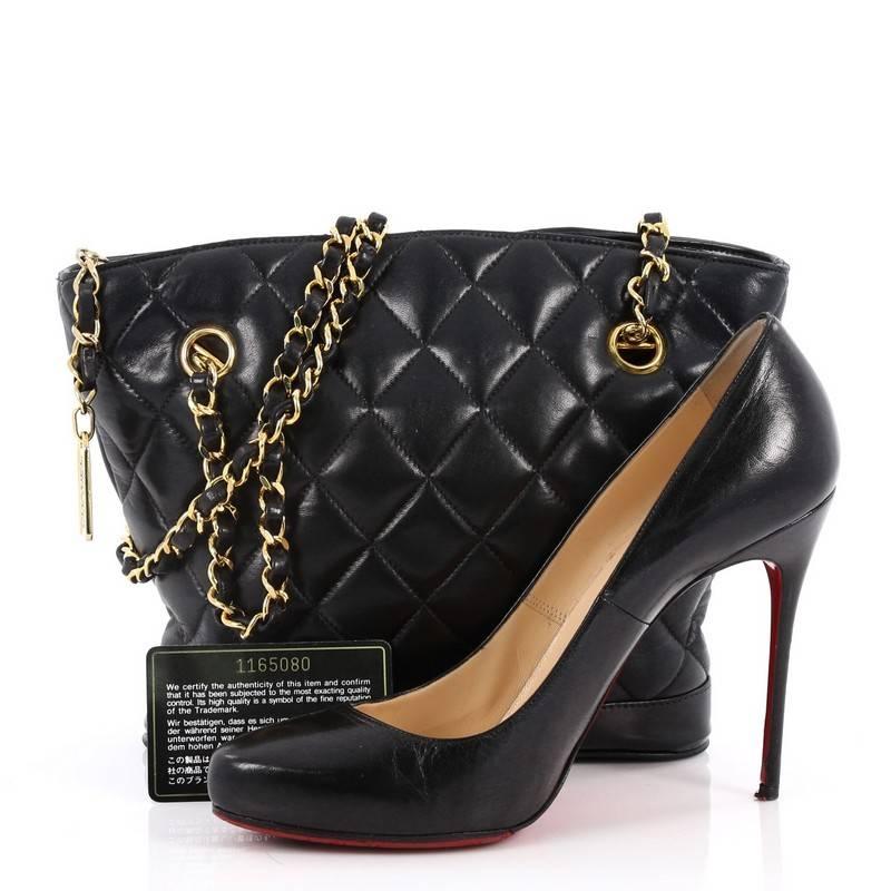 This authentic Chanel Vintage Fan Tote Quilted Lambskin Small is the perfect bag that complements any outfit. Crafted from black diamond quilted lambskin leather, this tote features dual woven-in leather chain with leather pads, and gold-tone