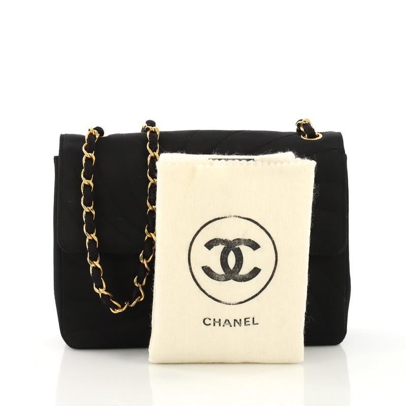 This Chanel Vintage Flap Bag Spiral Quilted Satin Small, crafted in black spiral quilted satin, features woven-in-satin chain link strap and gold-tone hardware. Its CC turn-lock closure opens to a black satin interior with zip and slip pockets.