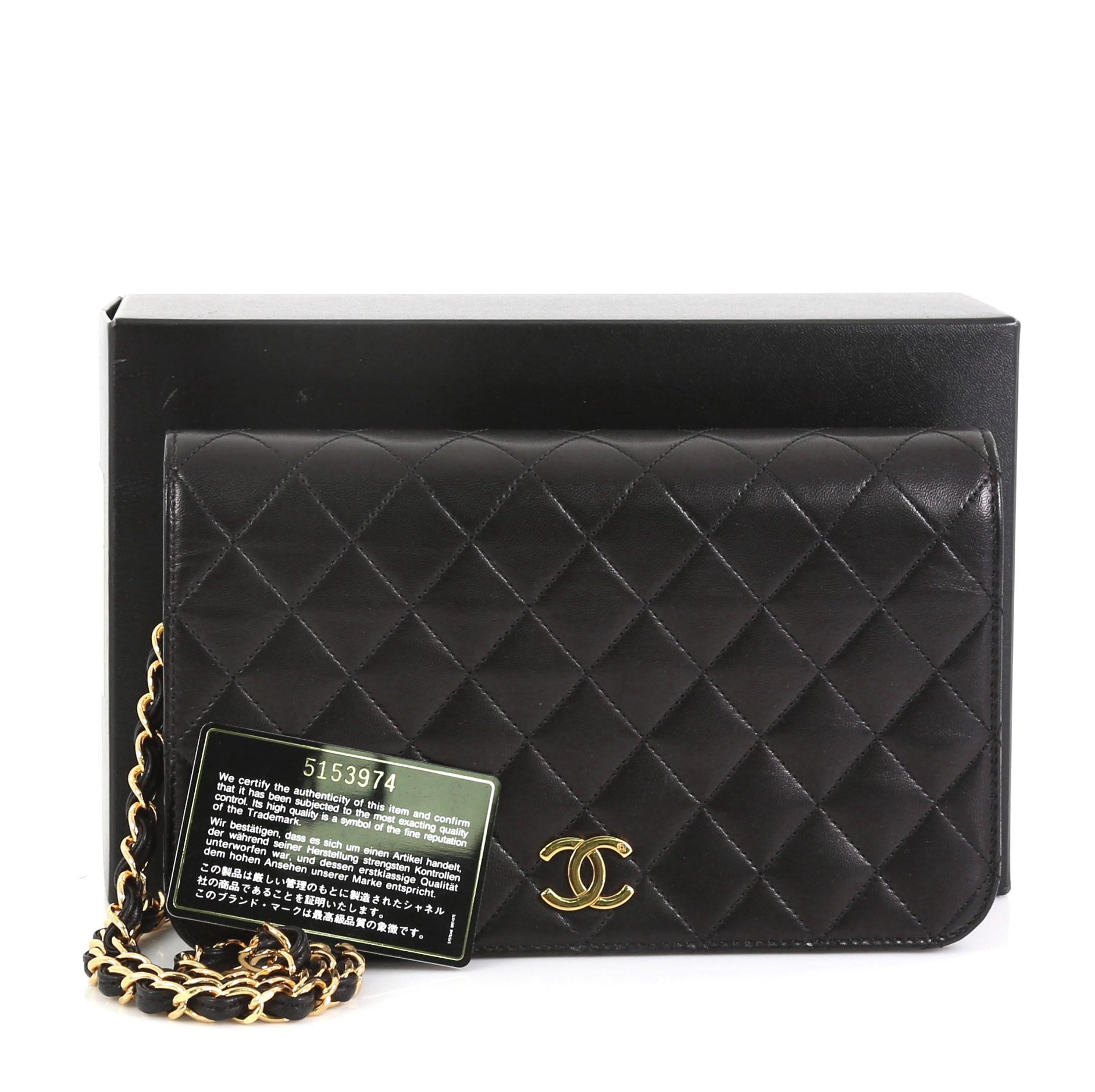 This Chanel Vintage Full Flap Bag Quilted Lambskin Small, crafted in black quilted lambskin leather, features woven-in leather chain link strap and gold-tone hardware. Its CC turn-lock closure opens to a red leather interior with zip pocket.