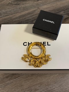 CHANEL Vintage Gold Circle Brooch with CC Dangling Logo Accents