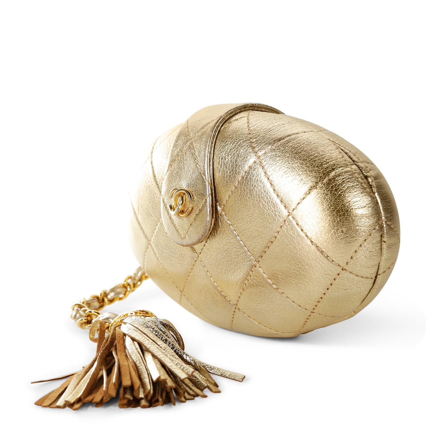Chanel Gold Oval Leather Vintage Clutch - excellent condition
 A rare style in exquisite condition, it is a must have for collectors.
Gold metallic leather small oval clutch is stitched in signature Chanel diamond pattern. Large leather tassel on