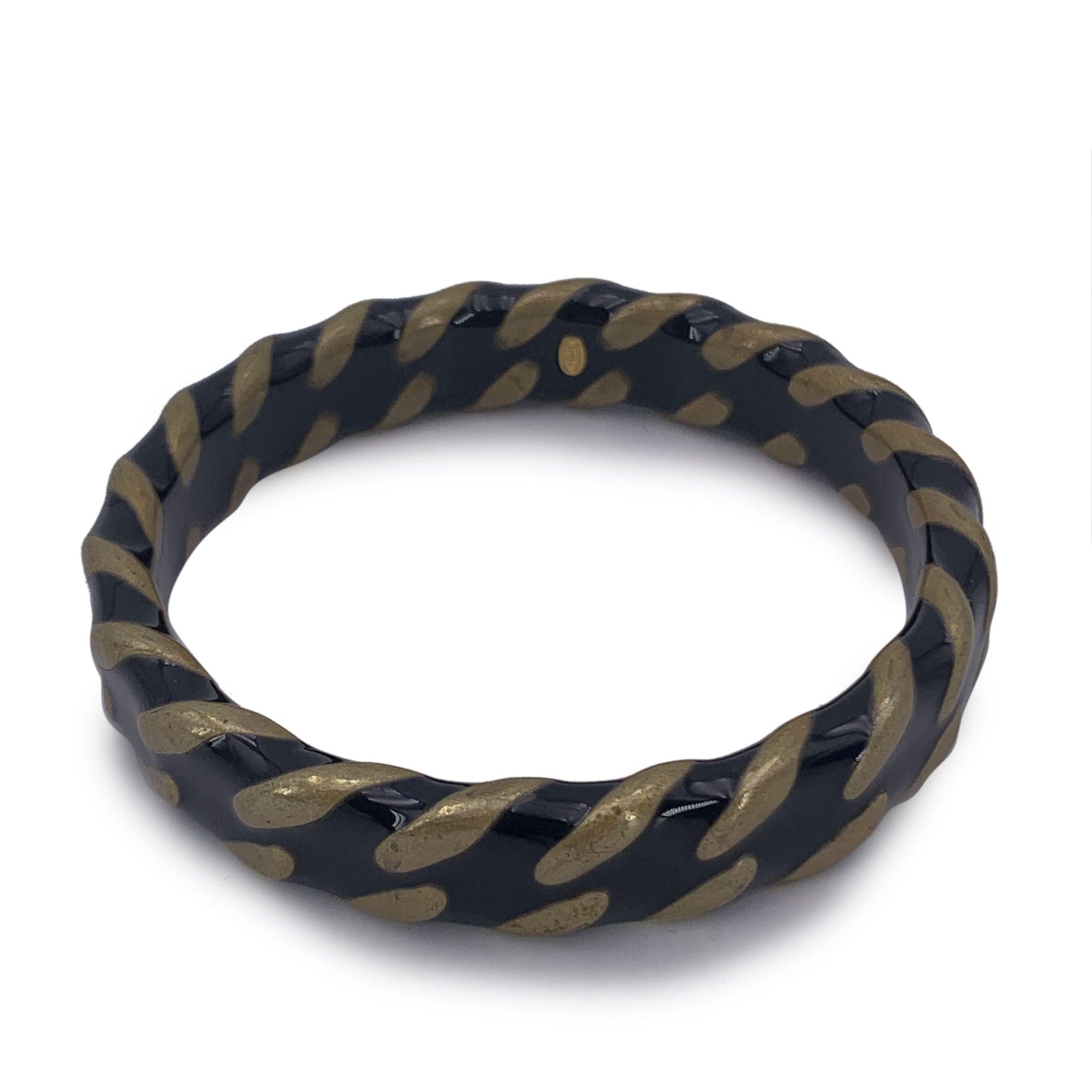 Vintage bangle bracelet by CHANEL. Gold metal and black enameled design with CC logo. Stamped 'Chanel 97 CC A - Made in France' oval mark stamped internally. Will fit up to approx. 7.5 inches - 19 cm wrist. Condition A - EXCELLENT Gently used.