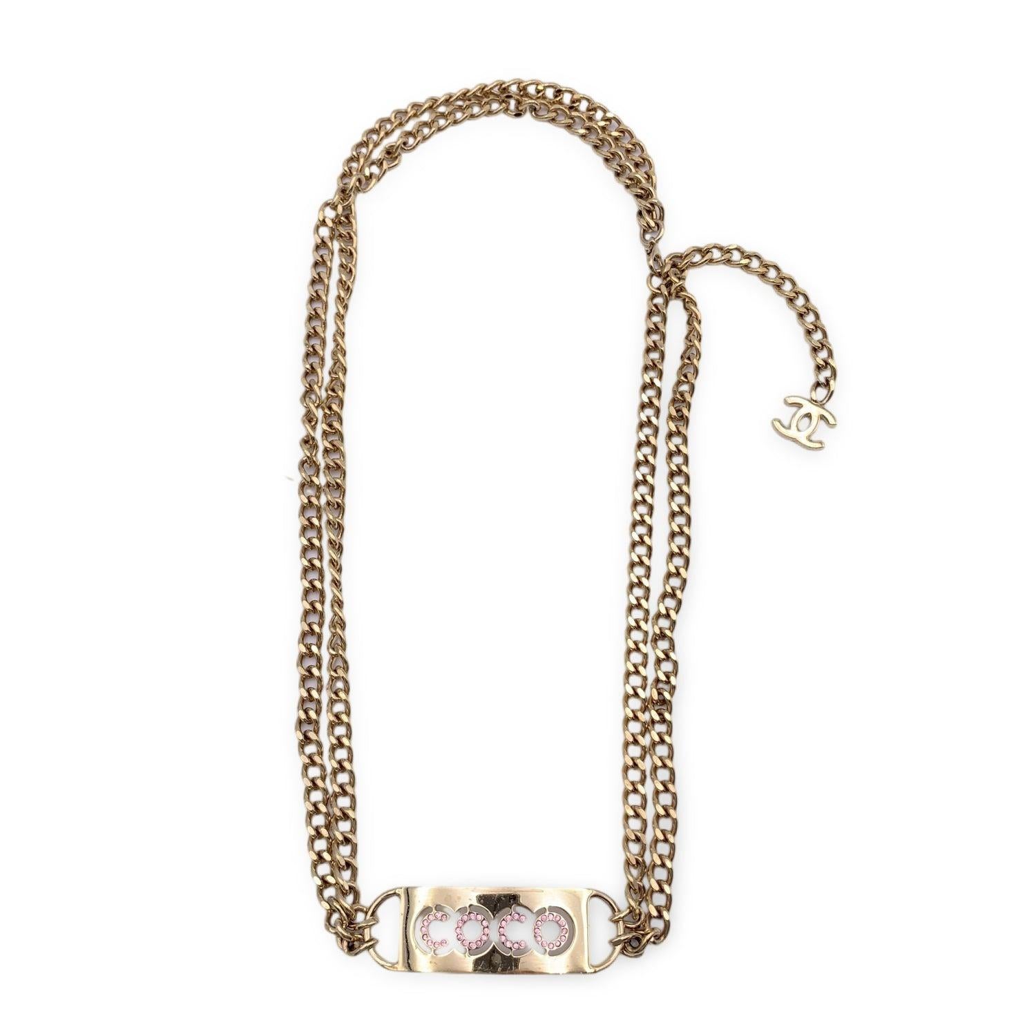 Chanel heavy gold metal chain belt . Period/Era: 2002. It is very versatile and will complete every look (you can use it as a necklace or as a belt). It features a rectangular tab with crystals COCO signature in the center. Lobster closure. Total