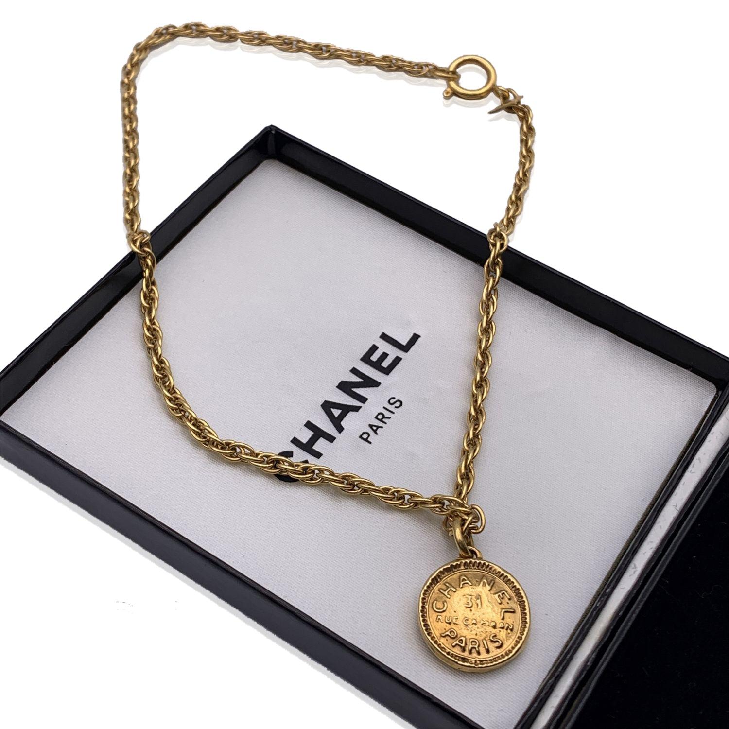 Vintage gold metal chain necklace and round 'Chanel 31 Rue Cambon Paris' medallion pendant. Spring ring closure. Necklace's length 16 inches - 40.6 cm. 'CHANEL - CC - Made in France' oval tab on the pendant Condition A - EXCELLENT Gently used.