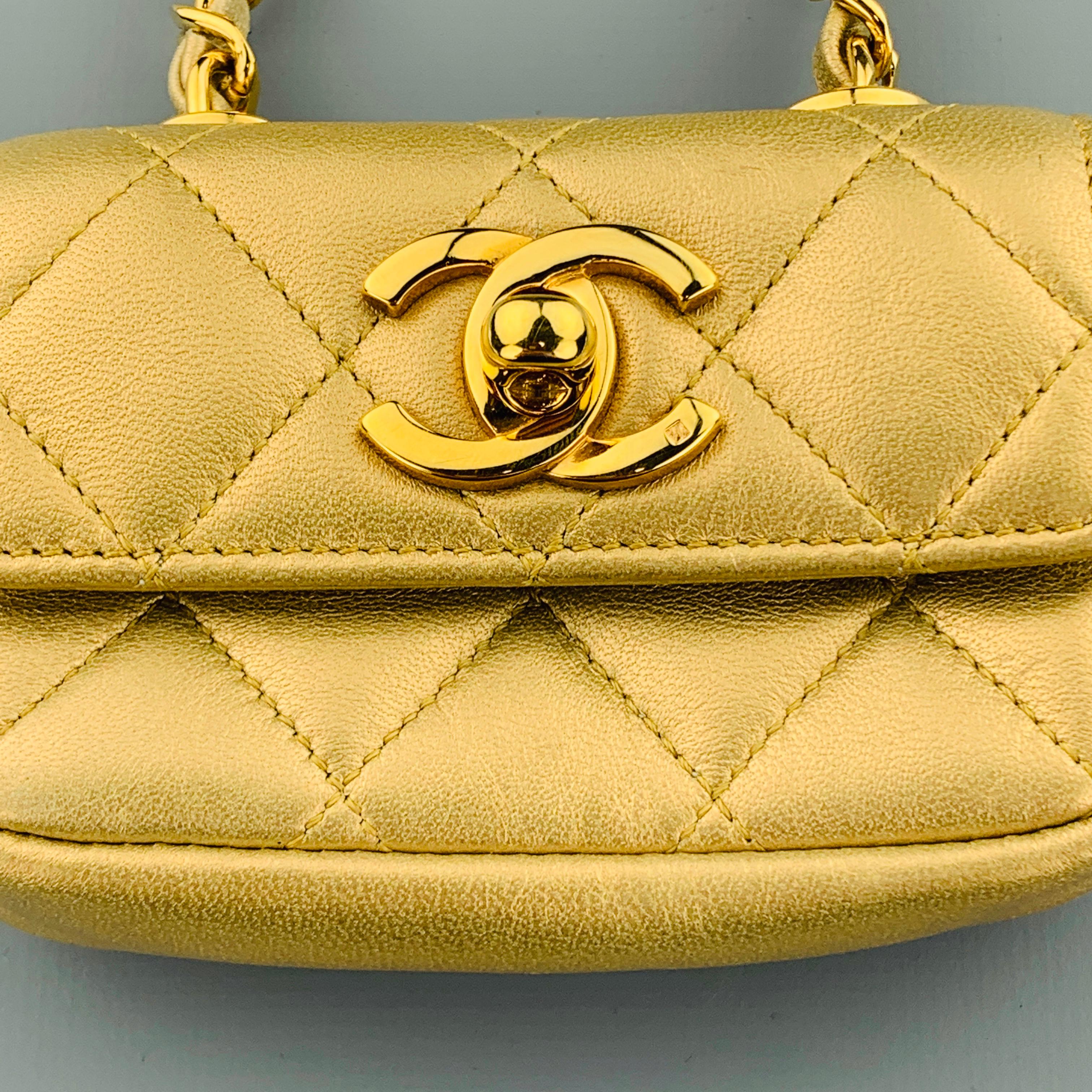 Vintage CHANEL mini purse coin pouch comes in metallic gold quilted leather with a flap top, yellow gold tone CC logo turn lock closure, and leather woven chain with Belt loop. Made in Italy.
 
Excellent Pre-Owned Condition.
Marked: 2308426
