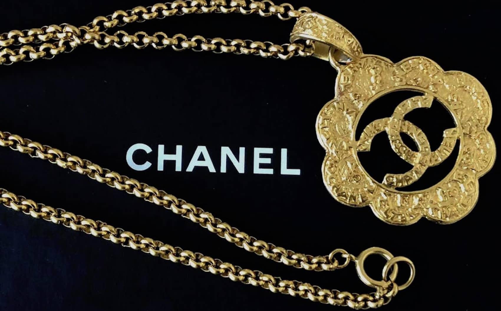 This wonderful rare, 1995 Chanel gold plated cutout CC logo hammered medallion flower chain necklace has the interlocking CC’s with CHANEL writing all around the medallion flower. It is from 1995 and it is hallmarked Chanel with the year behind and