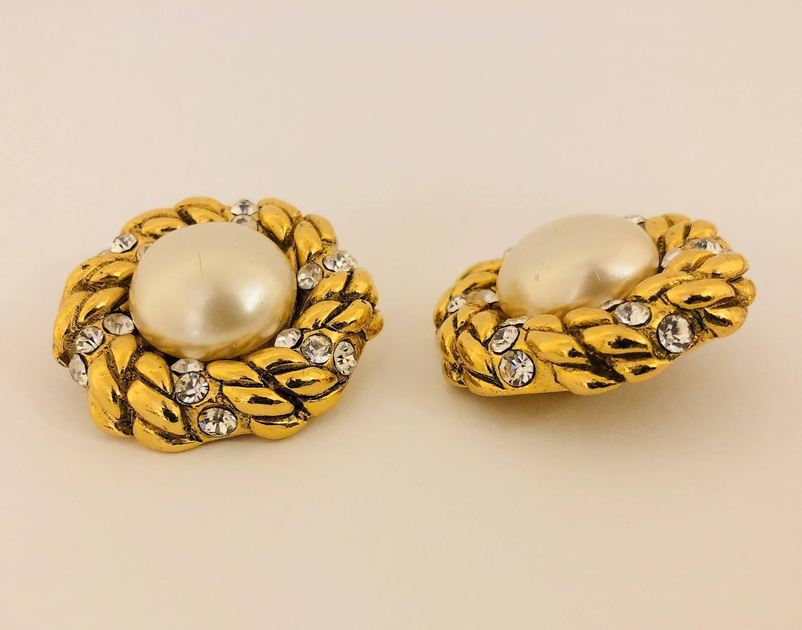 Gold tone Chanel vintage earrings featuring faux pearls and crystal details with clip-on closures looks as new as first day purchased.  The gold tone rope design features in a pattern 3 crystal grouping all around the frame of the faux pearl located
