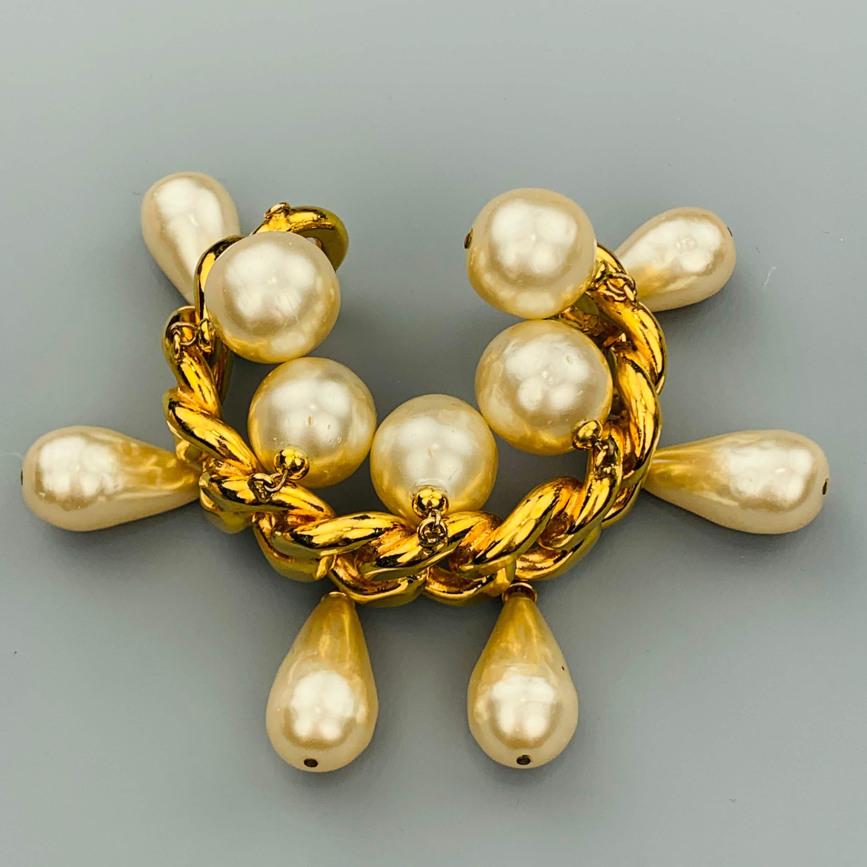 Vintage CHANEL Season 25 (Circa 1986-1992) cuff bracelet by Victoria de Castellaine features a stiff yellow gold tone chain cuff with round faux pearl charms on top and teardrop shaped faux pearls on bottom. Missing a round pearl. As-is. Made in