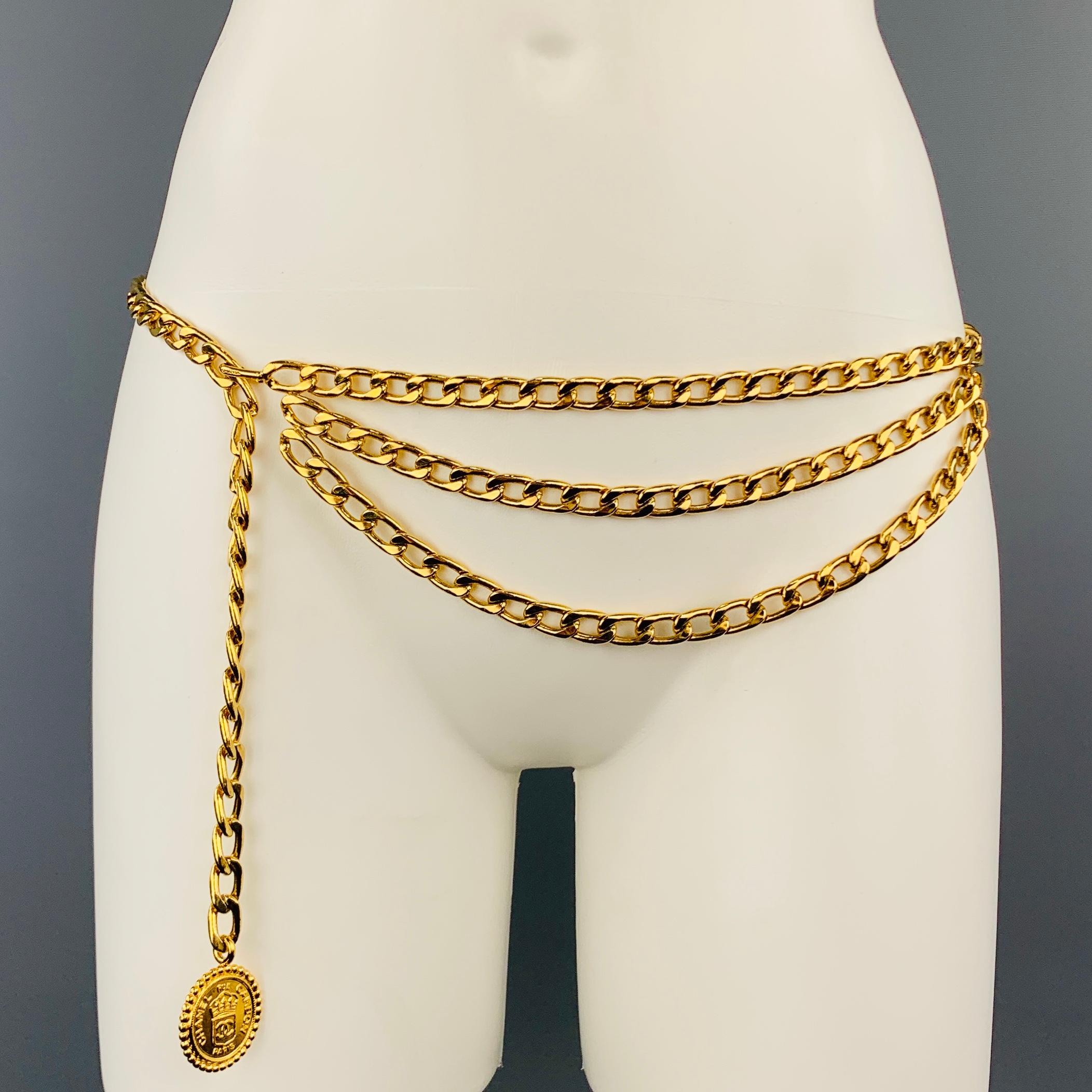 Vintage CHANEL belt circa 1970's comes in yellow gold tone metal and features a double drop chain detail, hook closure, and embossed 