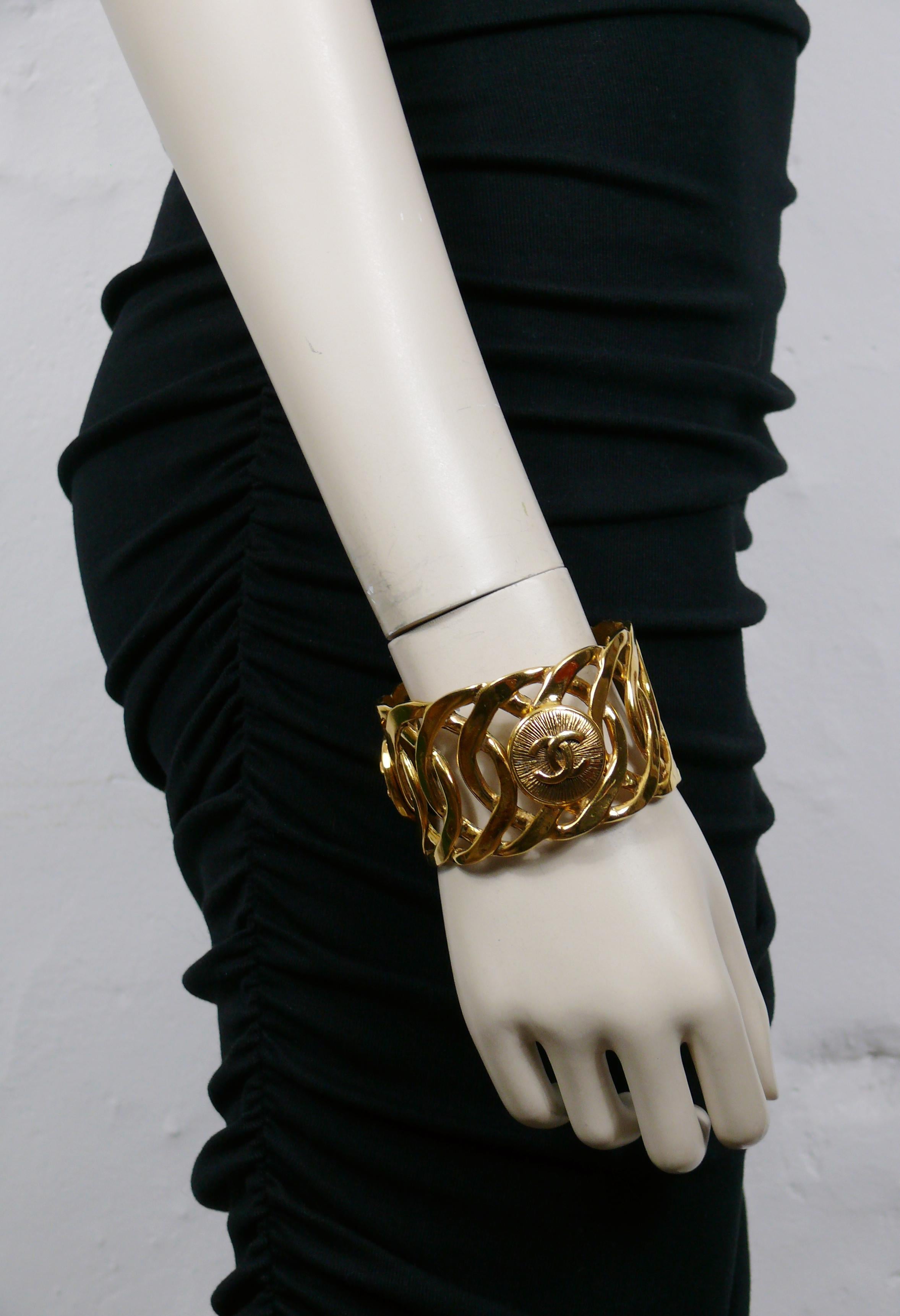 CHANEL vintage gold tone cuff bracelet featuring a rigid chain design embellished with 3 CC medallions.

Slips on (no clasp).

Embossed CHANEL Made in France.

Indicative measurements : inner circumference approx. 21.05 cm (8.29 inches) / width