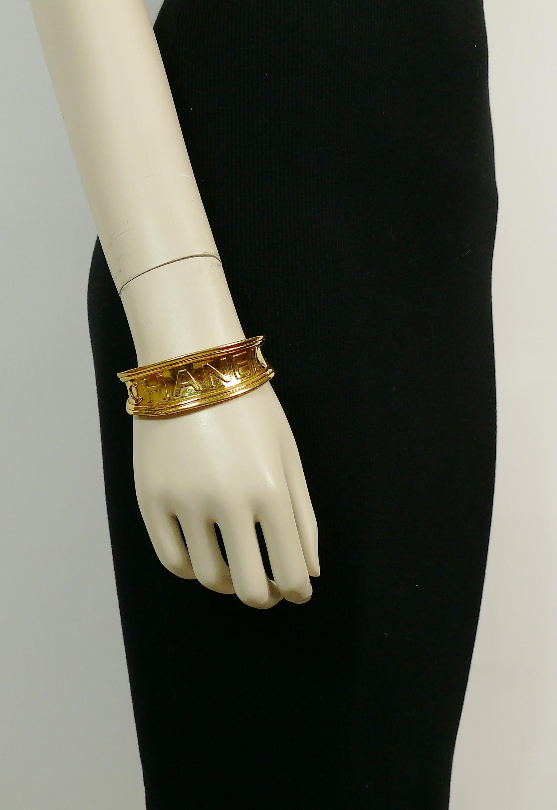 CHANEL vintage gold toned cuff bracelet featuring CHANEL letters script monogram.

From the Spring/Summer 1996 Collection.

Embossed CHANEL 96 P Made in France.

Indicative measurements : inner measurements approx. 6 cm x 4.2 cm (2.36 inches x 1.65