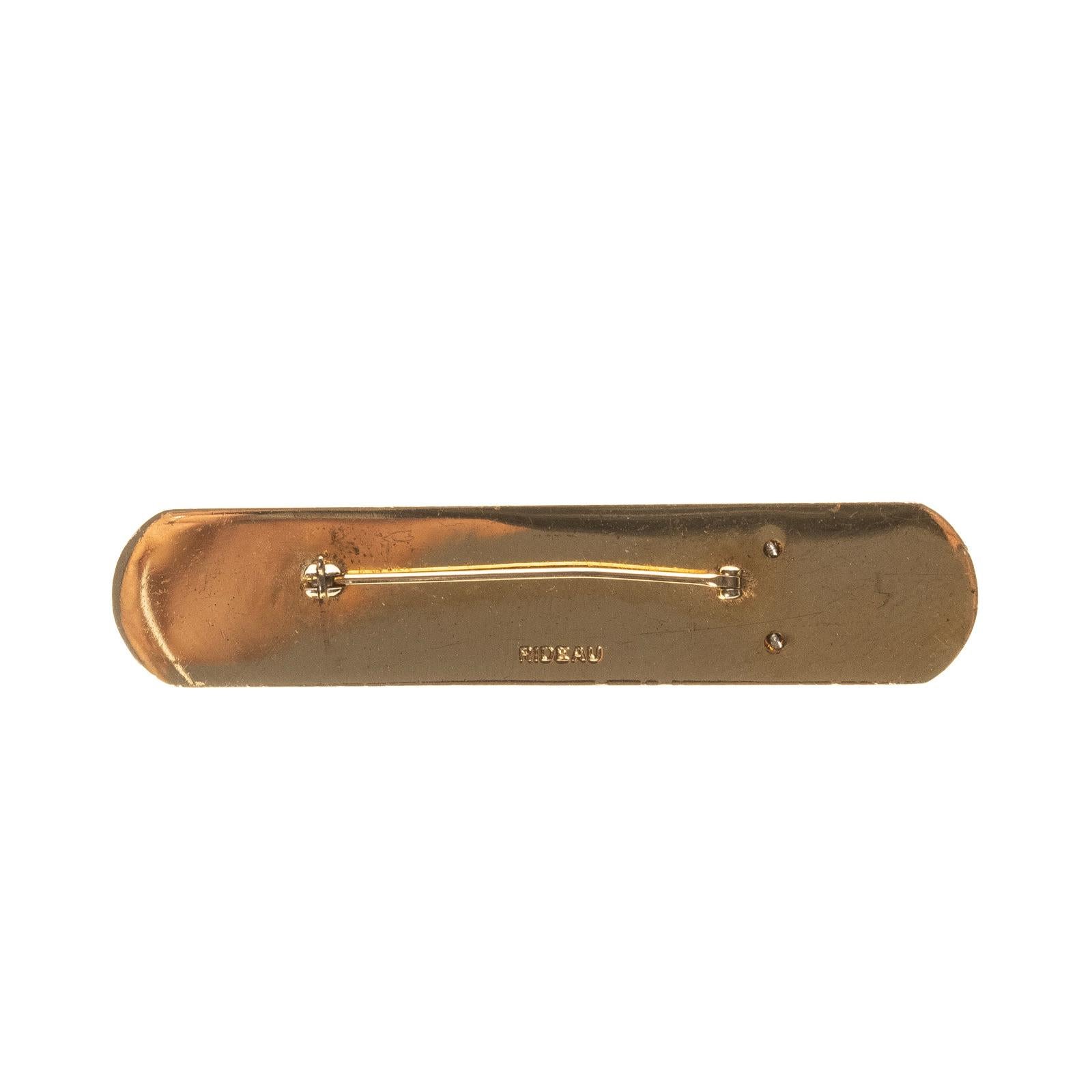 Chanel vintage specialist pin, a staff accessory from the Chanel cosmetics line. Roughly 2.5” long with logo engraved on the front, pin at the back to hold in place. 

COLOR: Gold 
MATERIAL: Metal 
MEASURES: W 2.5” x H 0.5”
COMES WITH: Chanel