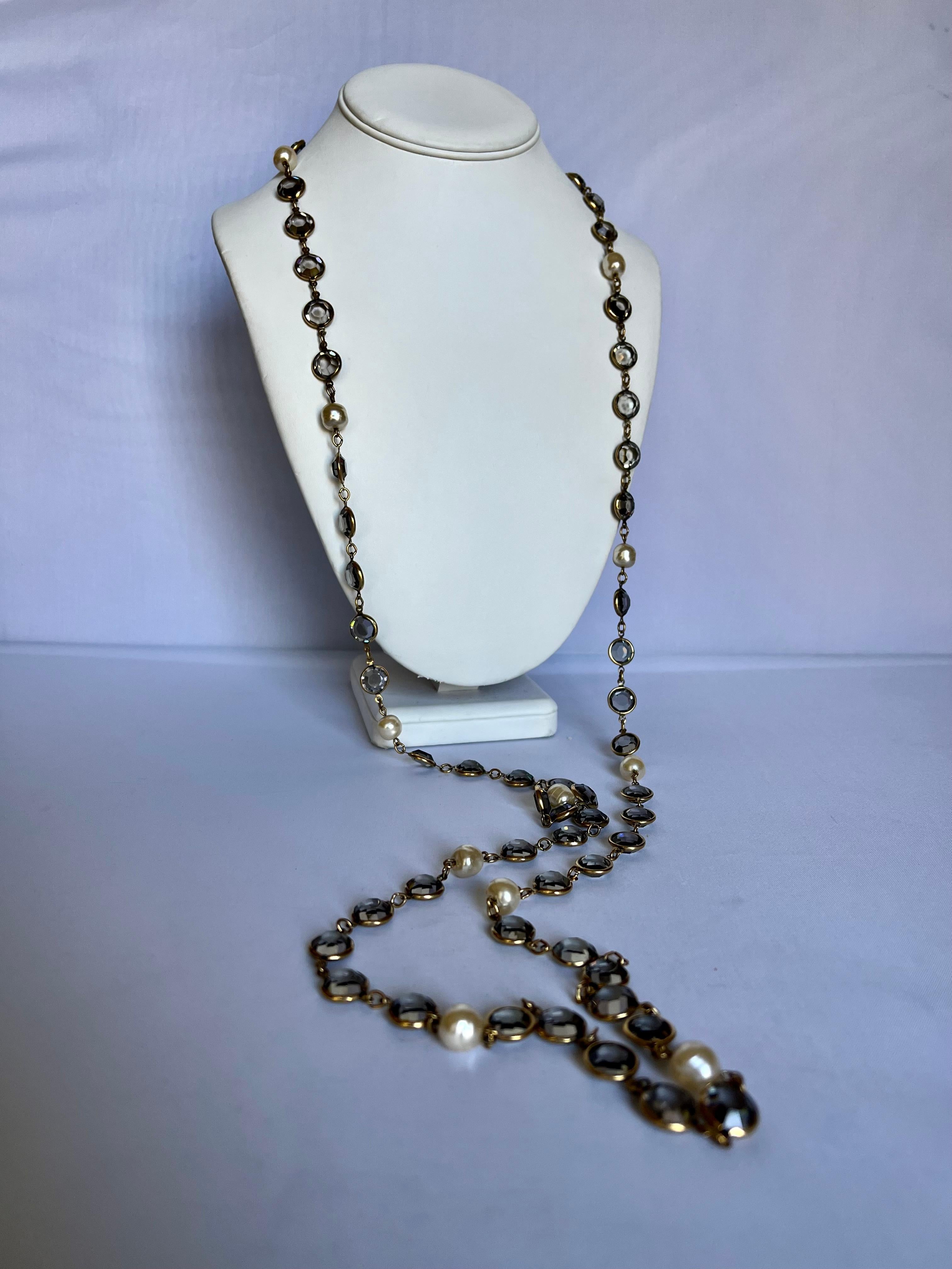 Versatile and classic signed vintage Chanel faux pearl and grey bevel set crystal long sautoire necklace. The necklace can be wrapped twice or triple around the neck. 