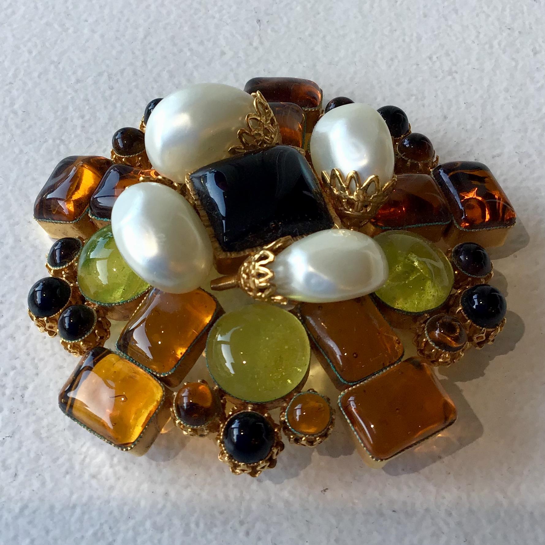 Chanel Vintage Gripoix Brooch. Textured, gold-tone, featuring multi-colored glass embellishments along with pin closure. Hook featured on the back to transform brooch into a necklace (see photo attached).