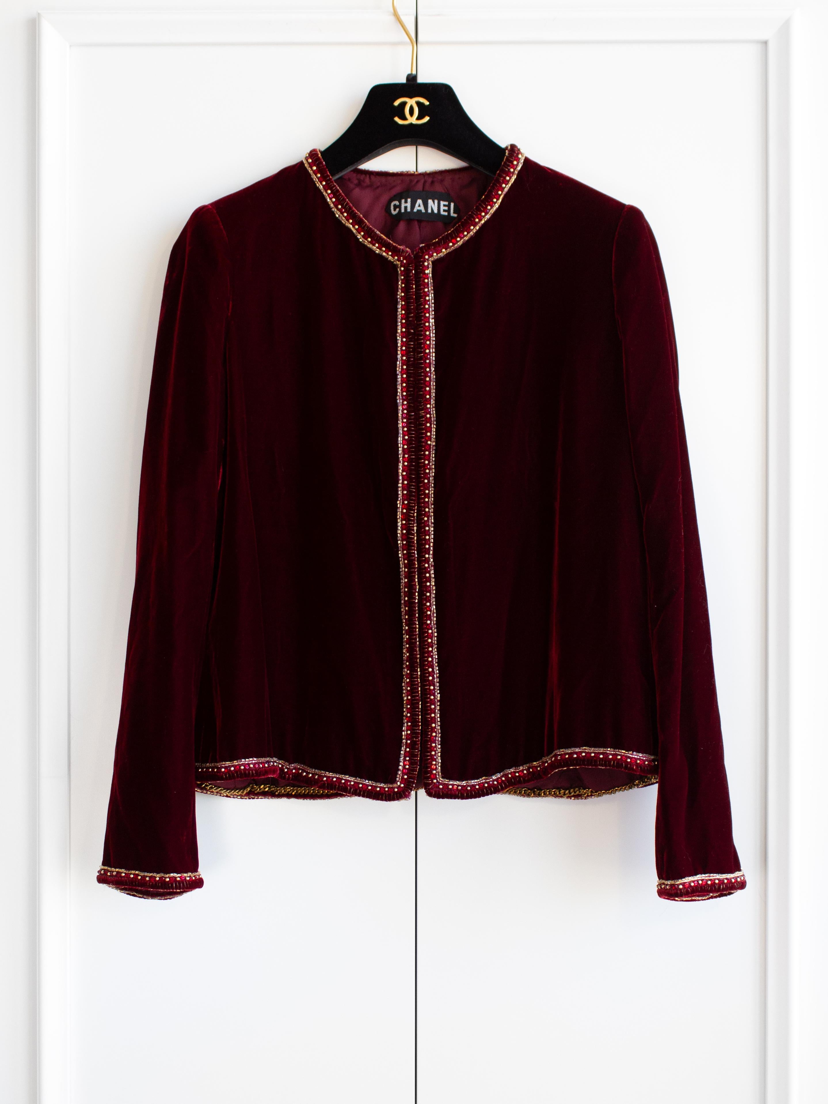 Transport yourself to the opulent past with this striking Chanel vintage haute couture jacket hailing from the late 1970s. This classic collarless jacket with a boxy cut, made from luxurious burgundy red velvet and adorned with intricate
