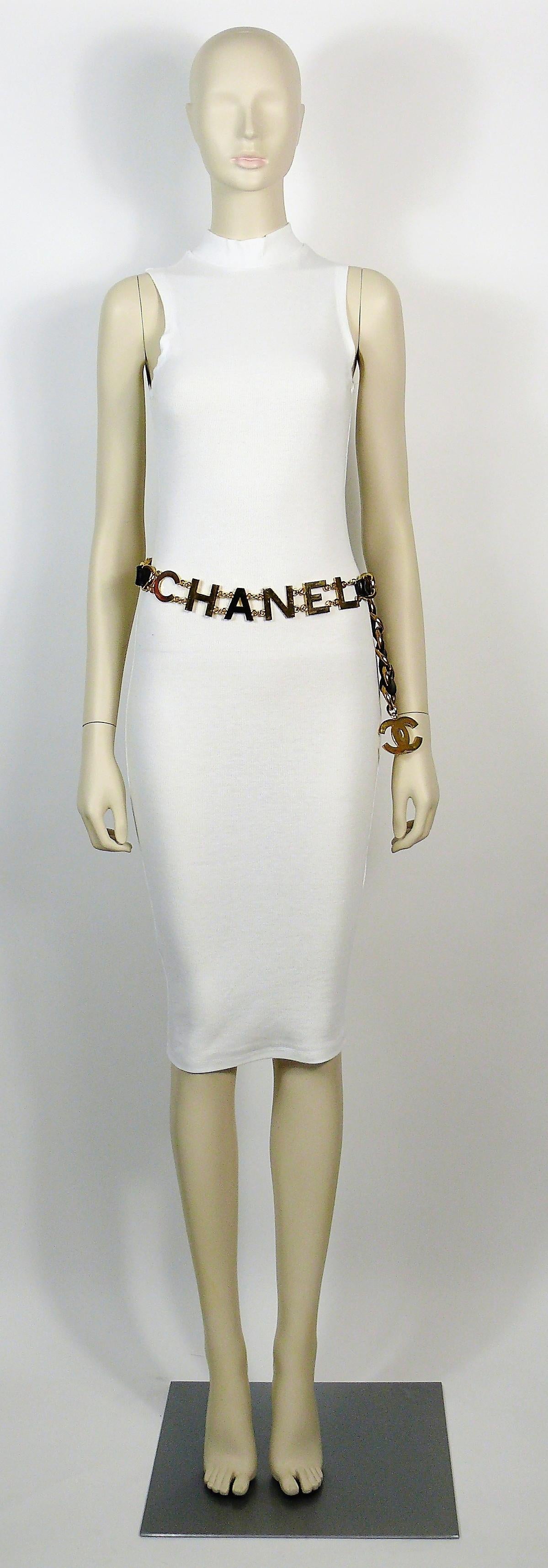 CHANEL vintage rare and iconic gold toned chain belt featuring spell out C O C O  C H A N E L with black intertwined leather.

Collection 29 (year 1994).

Hook clasp.

Marked CHANEL 29 Made in France.

Indicative measurements : adjustable length
