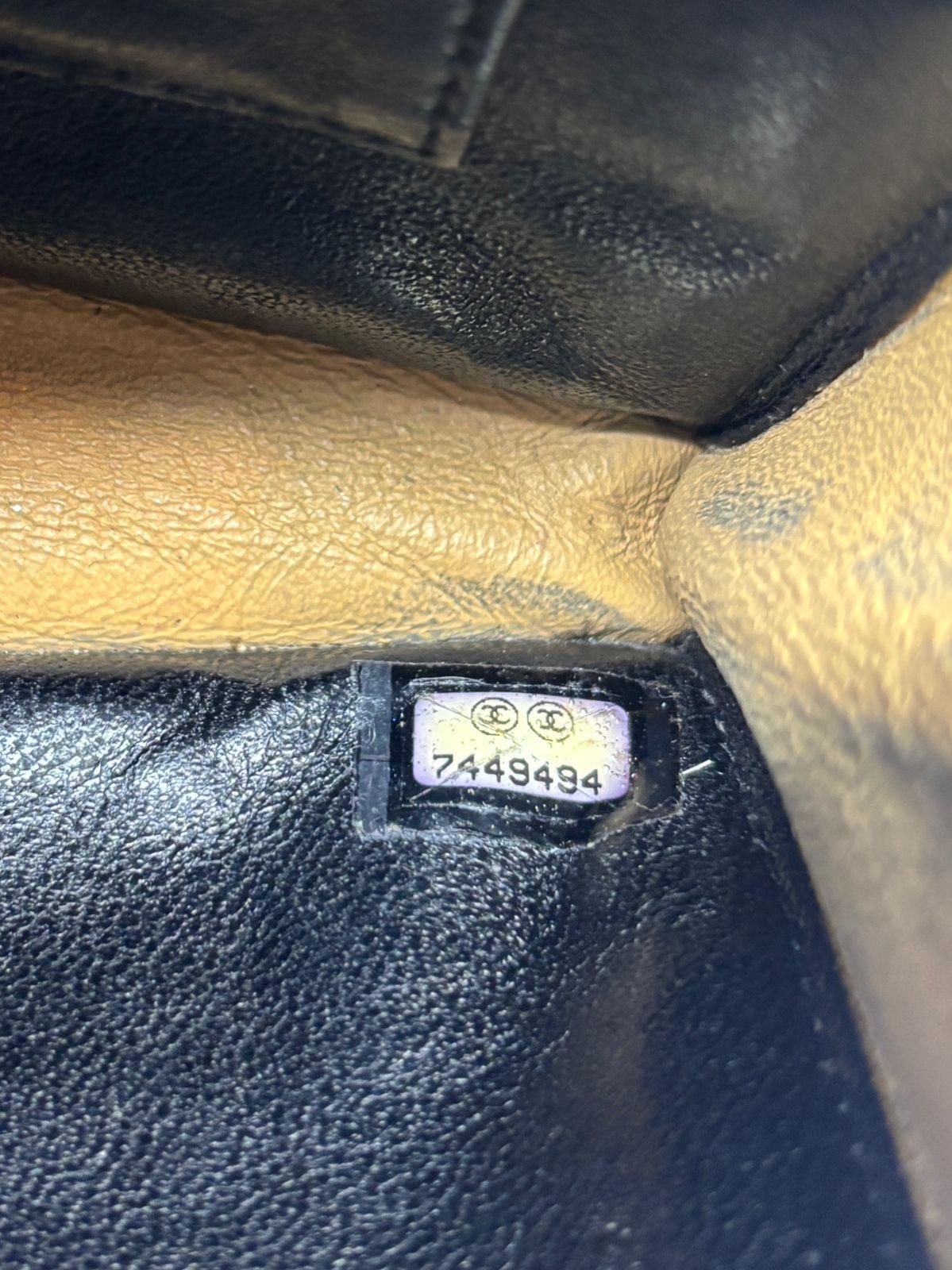 Unique vintage leather clutch in lambskin. The handcuff hardware details goes to the wrist. Visible storage and usage marks on the item. Slight darkening on the bottom area with scratches throughout the leather surface. Series #7. Comes with the