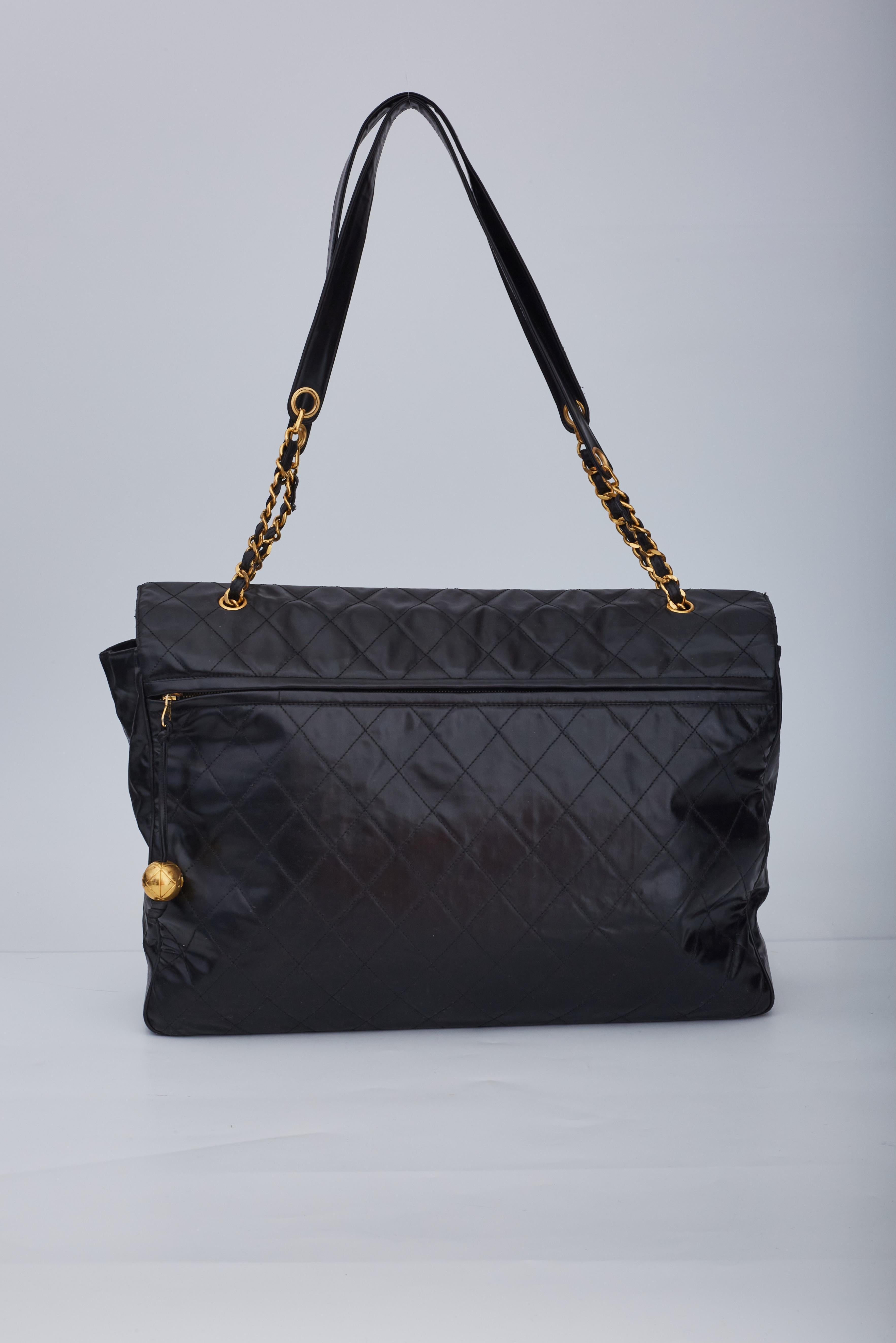 Chanel XXL flap bag of leather with large flap closer with turn lock closure.

Color: Black
Material: Calfskin leather
Serial No. 3665983
Year: 1994 to 1996
Comes with: Authenticity card
Condition: Good . Sscrews have been repaired by Chanel, bag