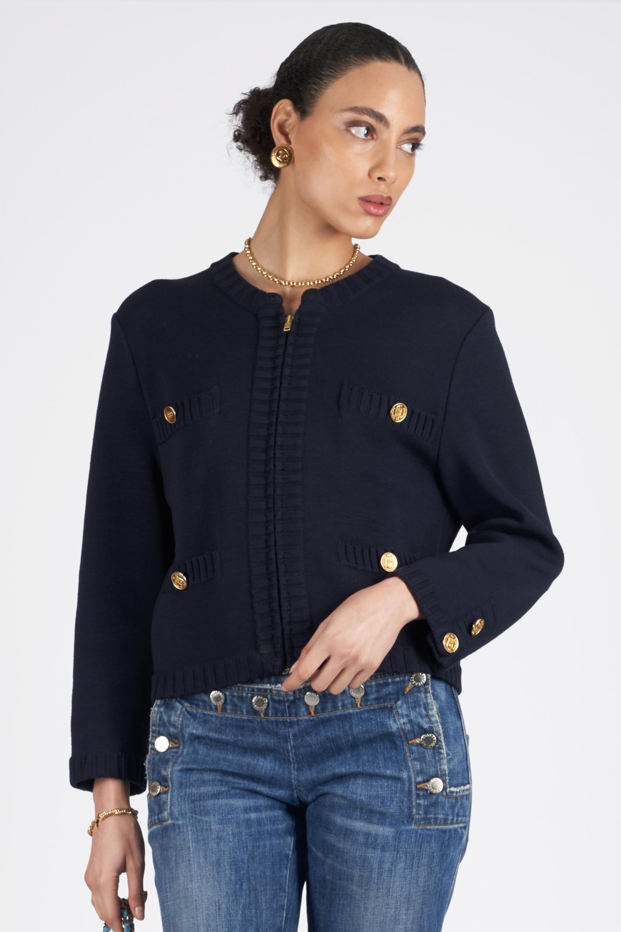 Nordic Poetry is excited to present this rare Chanel 1980’s navy cardigan. Features zip closure, pockets and Chanel engraved hardware. In excellent vintage condition. Authenticity guaranteed.

Label size: N/A
Modern size: UK: 8 to 10, US: 6 to 8,