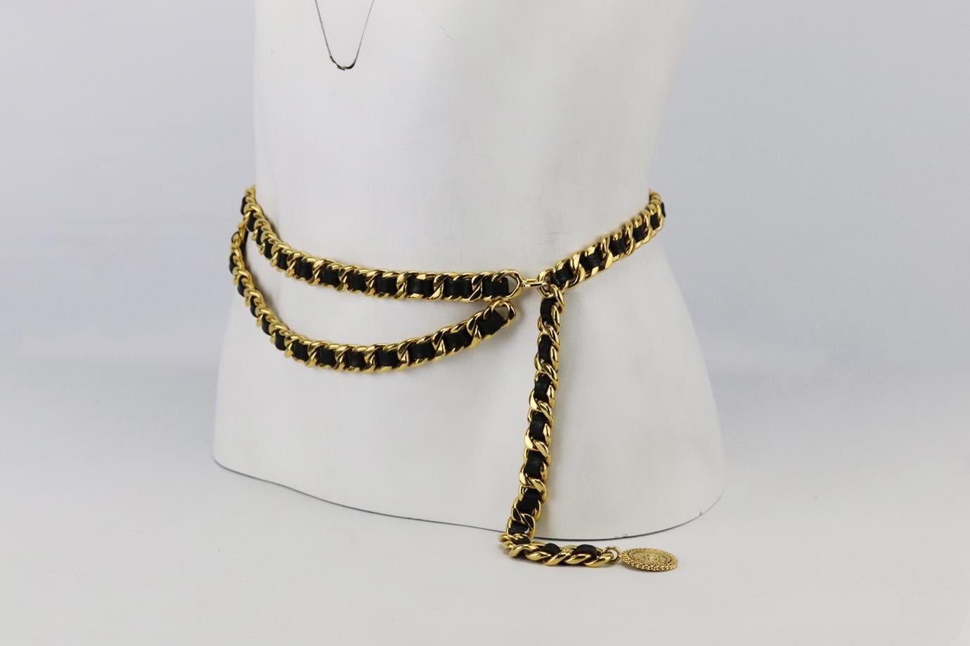 Chanel Vintage leather trimmed chain waist belt. Made from soft black leather interlocked with a gold-tone chain and finished with CC medallion. Black. Hook fastening at front. Length: 36.5 in. Width: 0.6 in