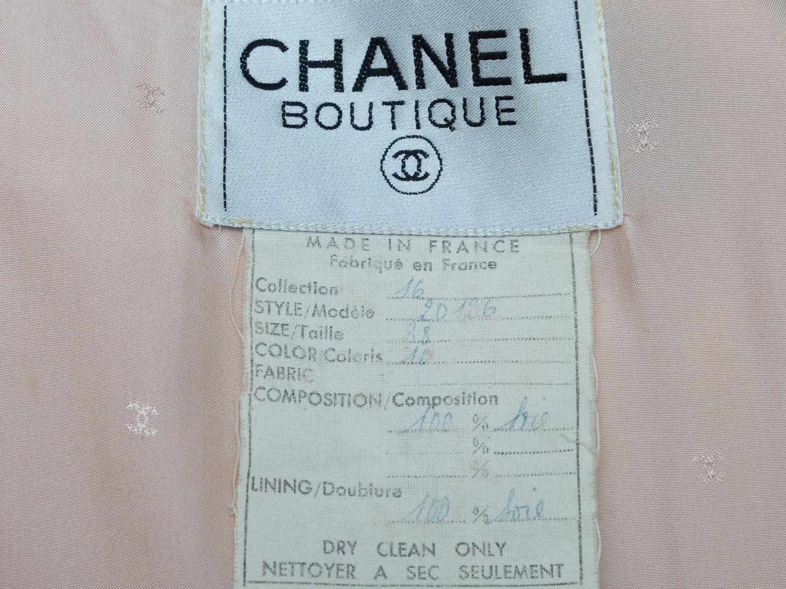 Product Details: Vintage light pink silk jacket by Chanel Boutique. Notched lapel. Dual bust pockets. Gold-tone button closures at center front. Designer size 40. 40