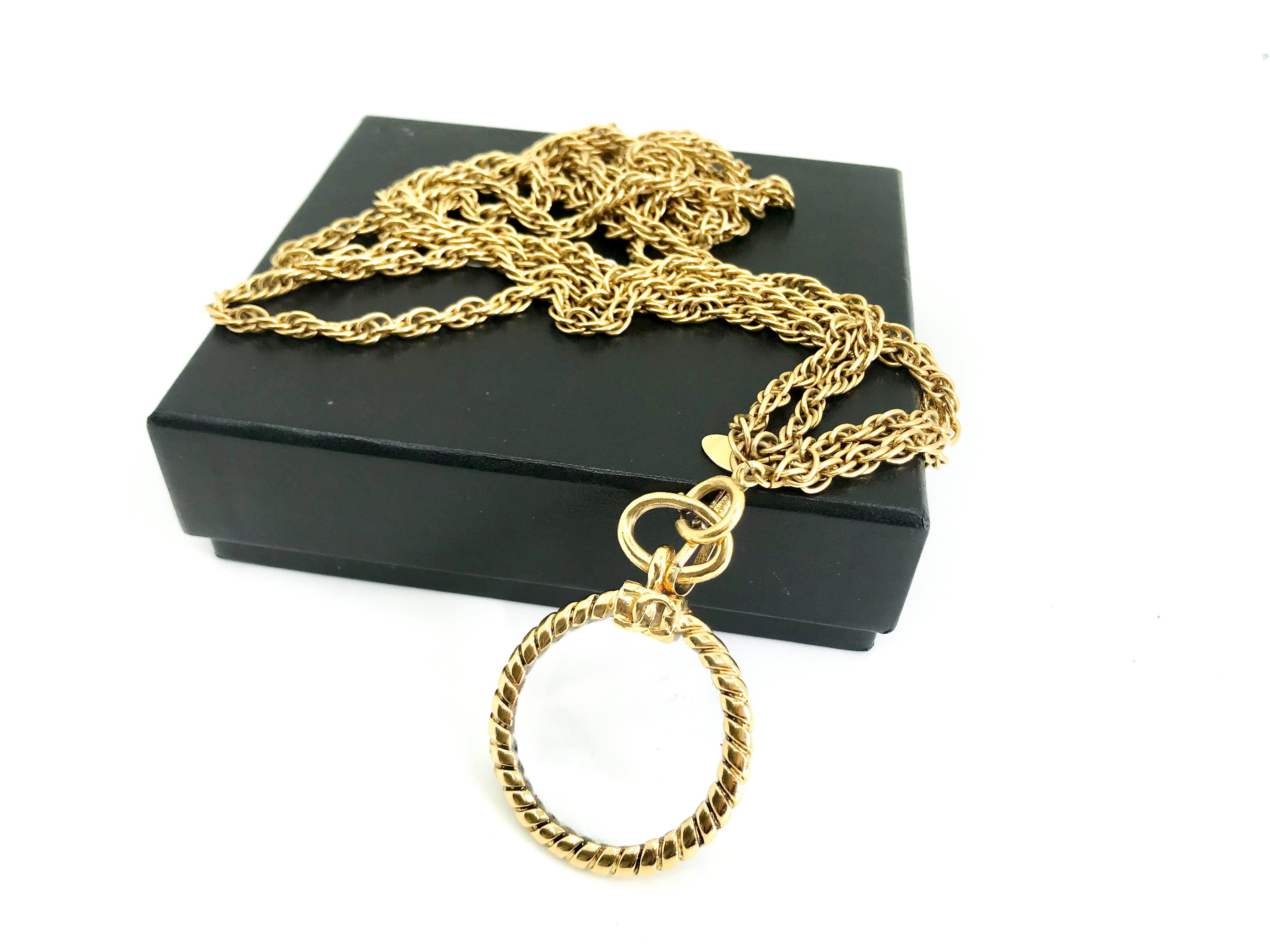 Chanel 1980s vintage long magnifying glass loupe gold plated pendant necklace.

This original magnifying pendant comes complete with a CC logo pedigree and a double 24 carat gold-plated chain. 

Comes with Chanel box.

Diameter of pendant – 1