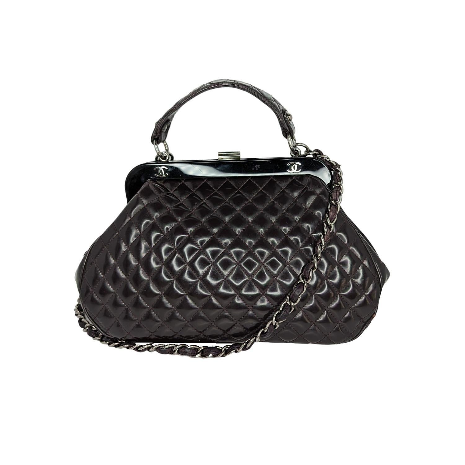 Eggplant quilted patent leather Chanel Mademoiselle Frame satchel with silver-tone hardware, single flat top handle, leather and chain-link shoulder strap, resin top frame featuring CC logo emblems, gray striped woven lining, dual pockets at