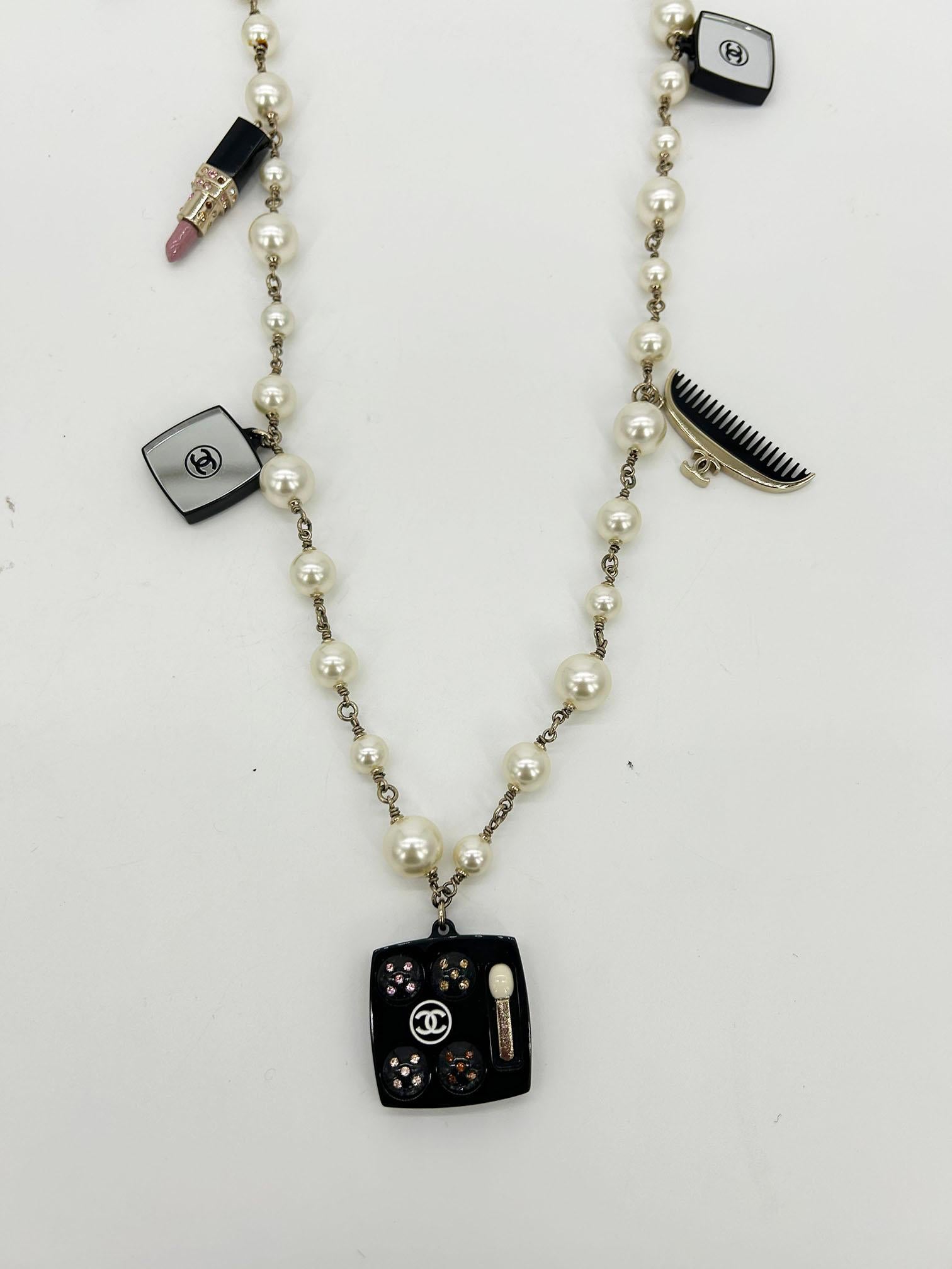 Chanel Vintage Make Up Charm Beaded Pearl Chain Necklace in excellent condition. Beaded pearls with chain links between and adorable acrylic beauty charms throughout. 3 square mirrors with black backs and multi colored crystals. clear perfume bottle