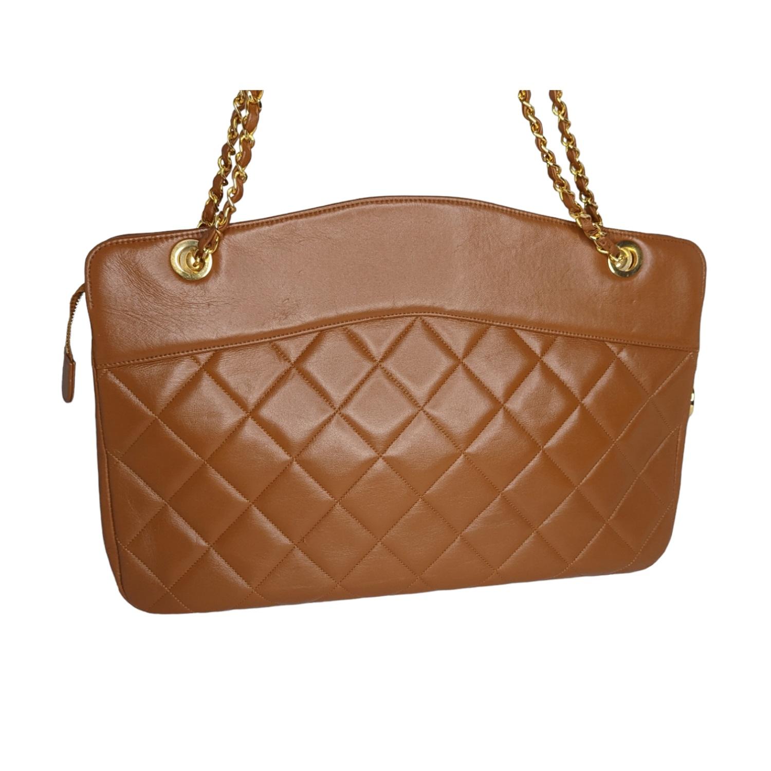 Chanel Vintage Camel colored diamond Lambskin leather tote with gold-tone hardware, leather woven chain shoulder straps, spacious interior lined in leather with three pockets and a single zipper CC medallion pull. Comes with a matching 7.5