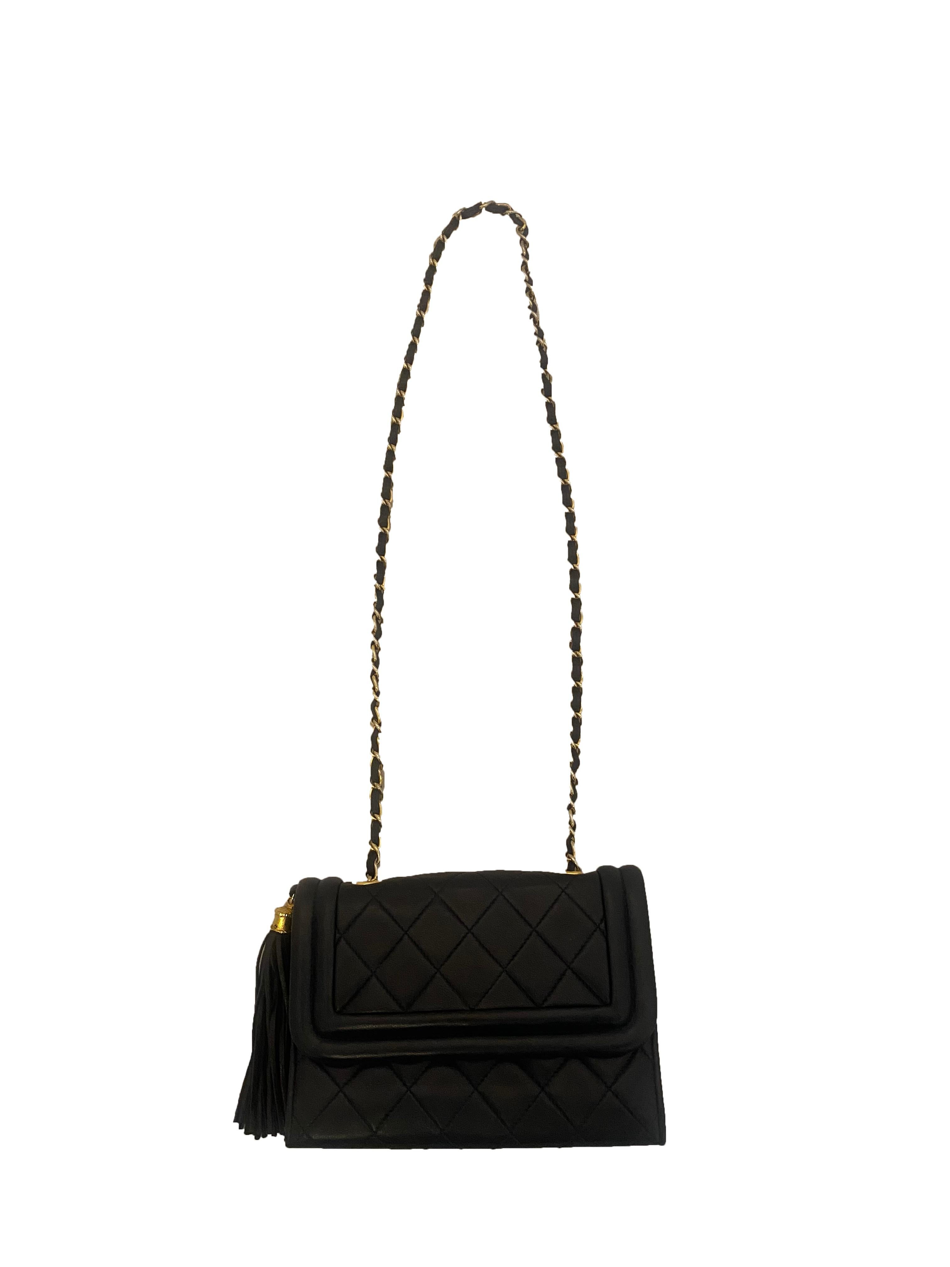 From circa 1986, this Vintage Flap handbag from Chanel isCrafted in navy matelassé lambskin leather and features a gold plated chain shoulder strap interlaced with navy leather. Features leather tassel with gold casing branded with the Chanel's