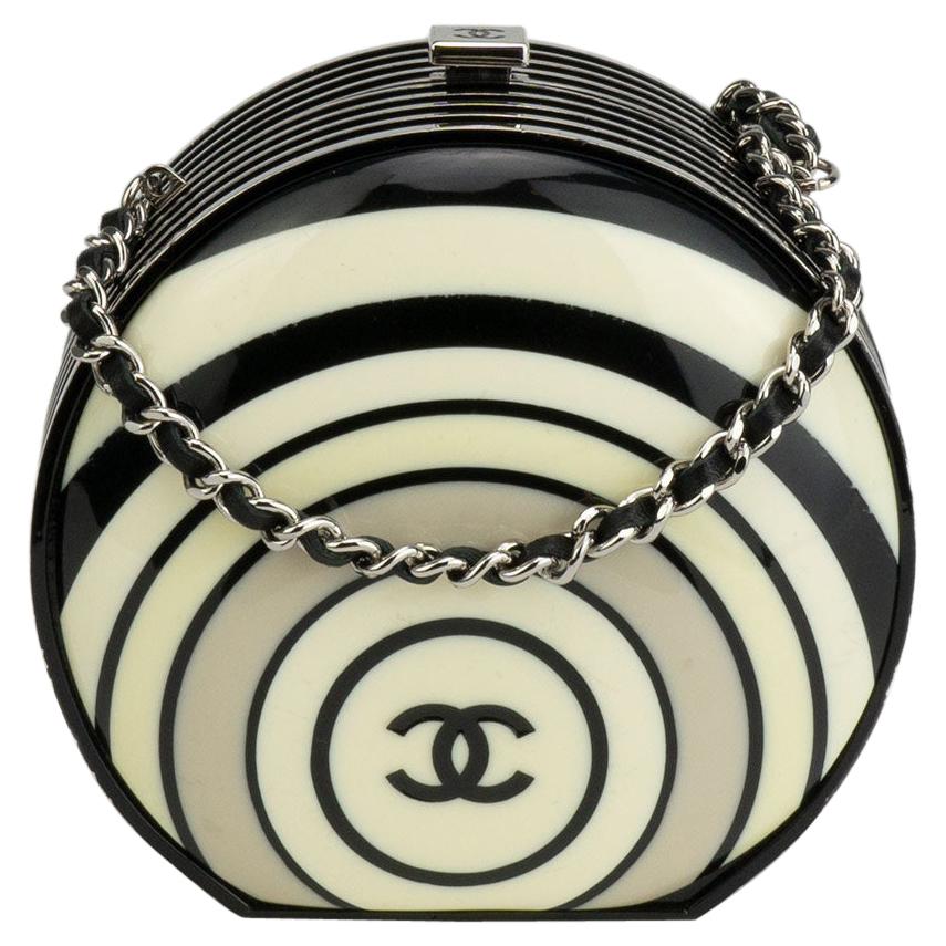 Chanel resin pillbox limited edition runway minaudière 

2006 {VINTAGE 15 Years}

Silver hardware
Circular resin design with CC logo 
Black leather interior lining
2.25”W x 4”H x 2”D
Strap Drop 23”

Made in France