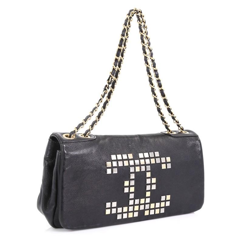 This Chanel Vintage Mosaic CC Flap Bag Studded Leather East West, crafted in black studded leather, features woven-in leather chain strap, CC Chanel logo in a mosaic stud pattern on the front, and gold and silver-tone hardware. Its magnetic snap