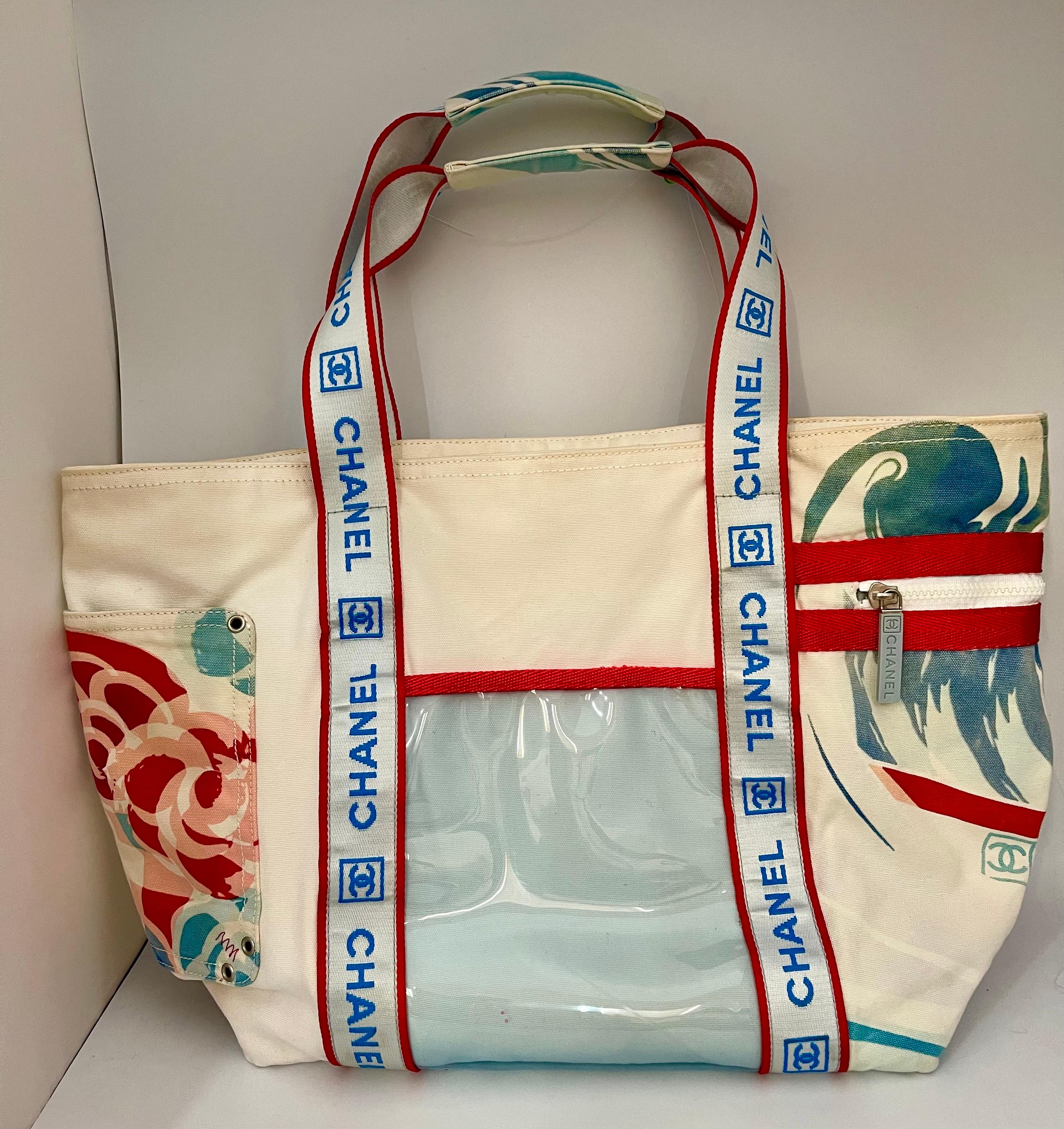 Authentic Chanel Sports line Large tote bag in blue white and red.
The has a pocket with a stud closure.
one side of the bag has a wave like design and bag has large straps going down the center embroidered with 