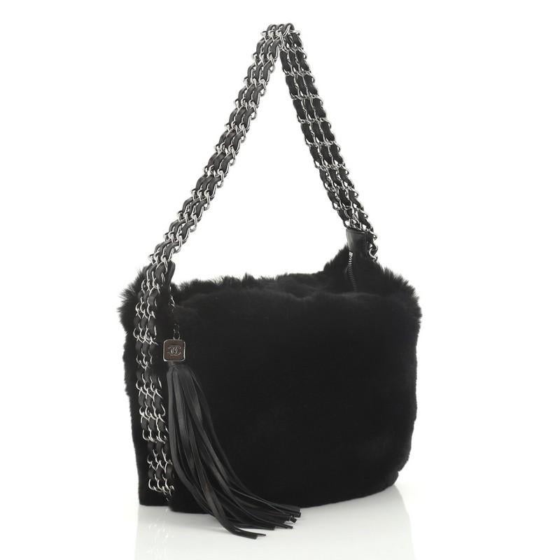 This Chanel Vintage Multichain Hobo Lapin Fur Medium, crafted from black fur, features multiple woven-in leather chain link straps and gunmetal-tone hardware. Its zip closure opens to a black fabric interior. Hologram sticker reads: 9504498.