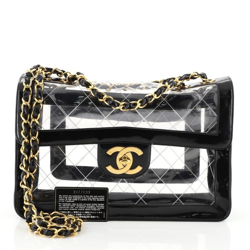 This Chanel Vintage Naked Flap Bag Quilted PVC Maxi, crafted in black leather and clear PVC, features a chain-link shoulder strap, frontal flap and gold-tone hardware. Its CC turn-lock closure opens to a clear PVC interior. Hologram sticker reads: