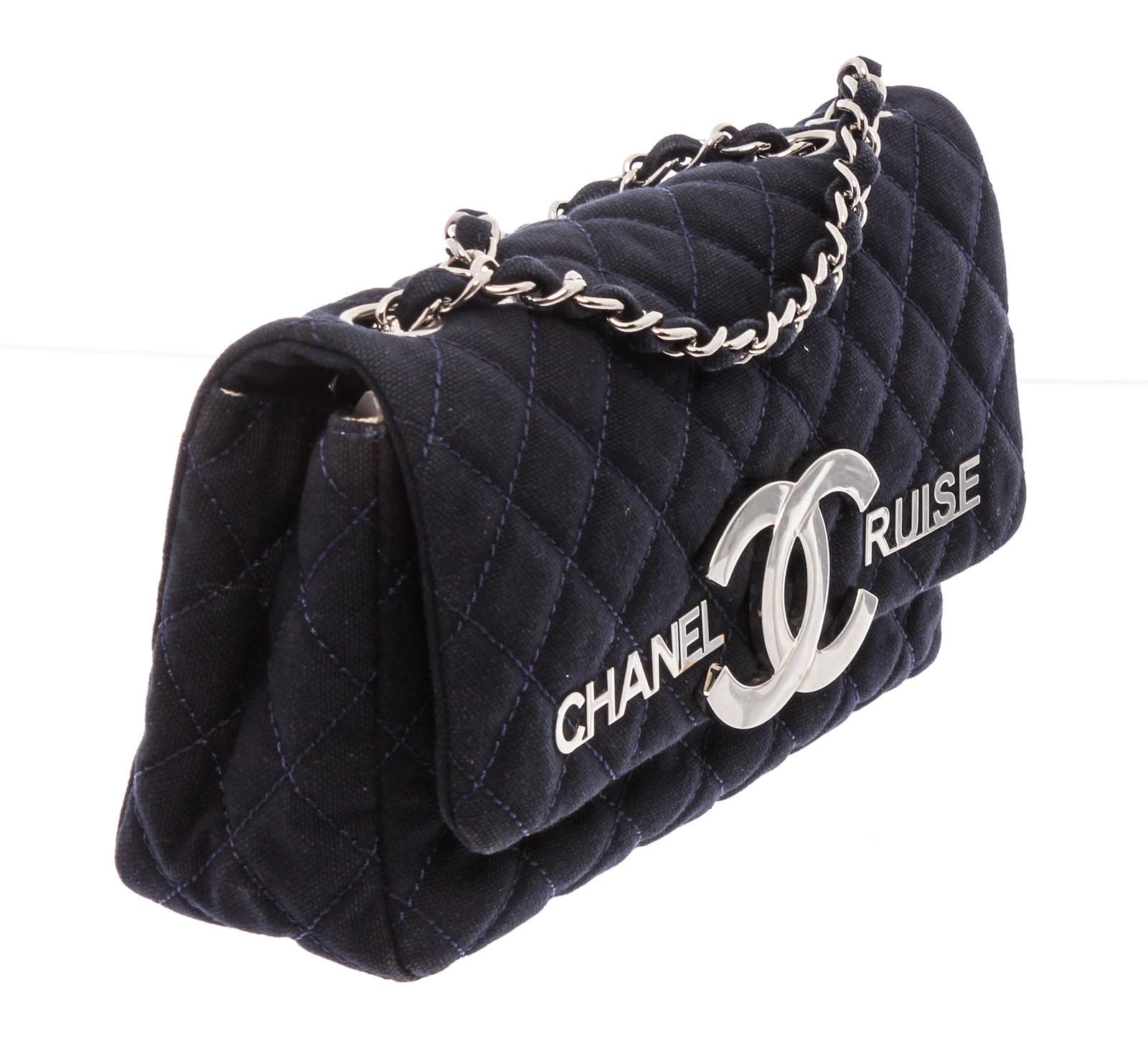 Navy Blue quilted fabric Chanel Vintage CC Cruise flap bag with silver-tone hardware, beige woven lining,  dual interior pockets; one zip closure and overall flap with CC folding closure.

21449MSC