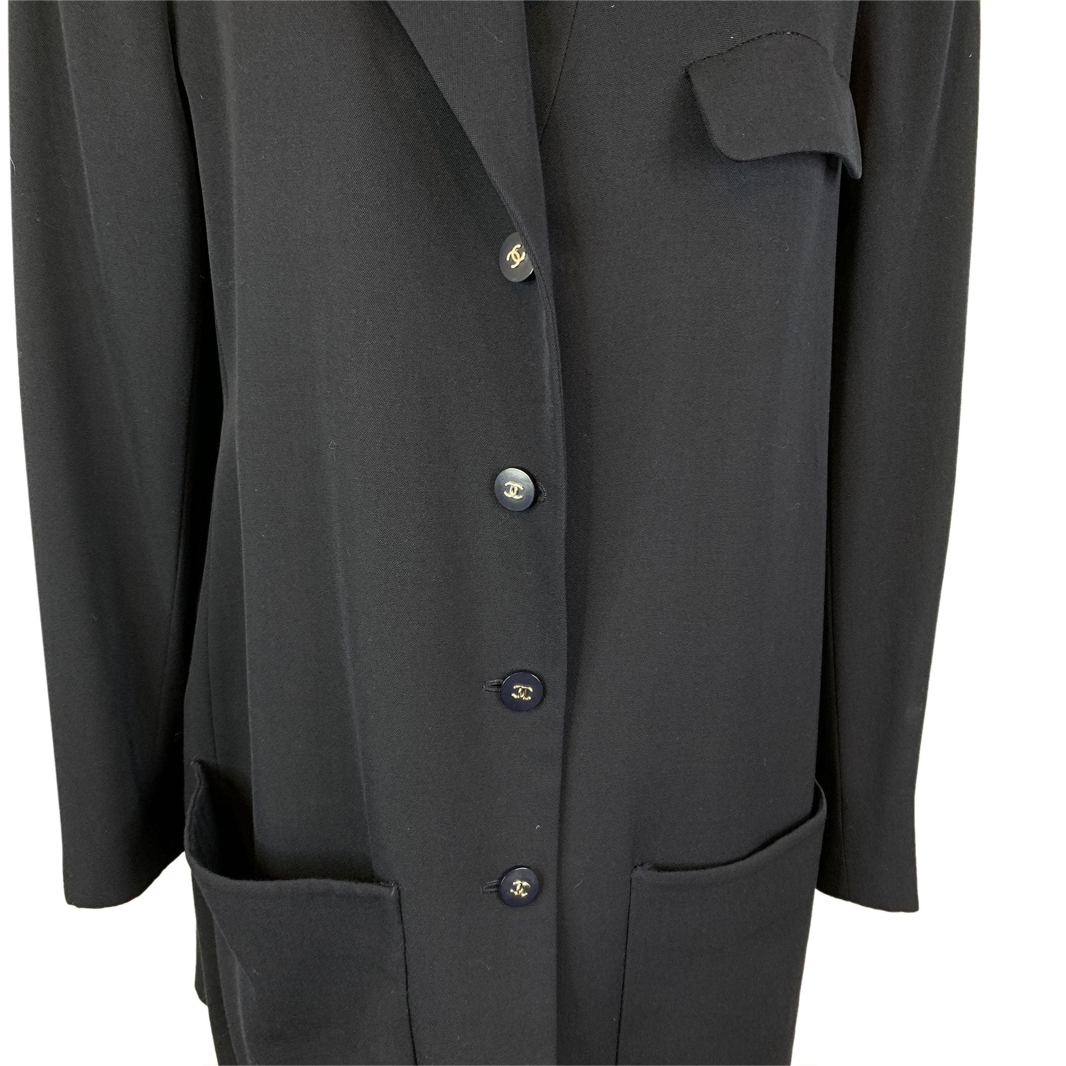 Embrace classic sophistication with this Chanel Vintage Blue Wool Dust Coat, a true testament to timeless style. Crafted from 100% wool, this piece exudes warmth and elegance, making it the perfect outerwear for those chic, transitional months. The