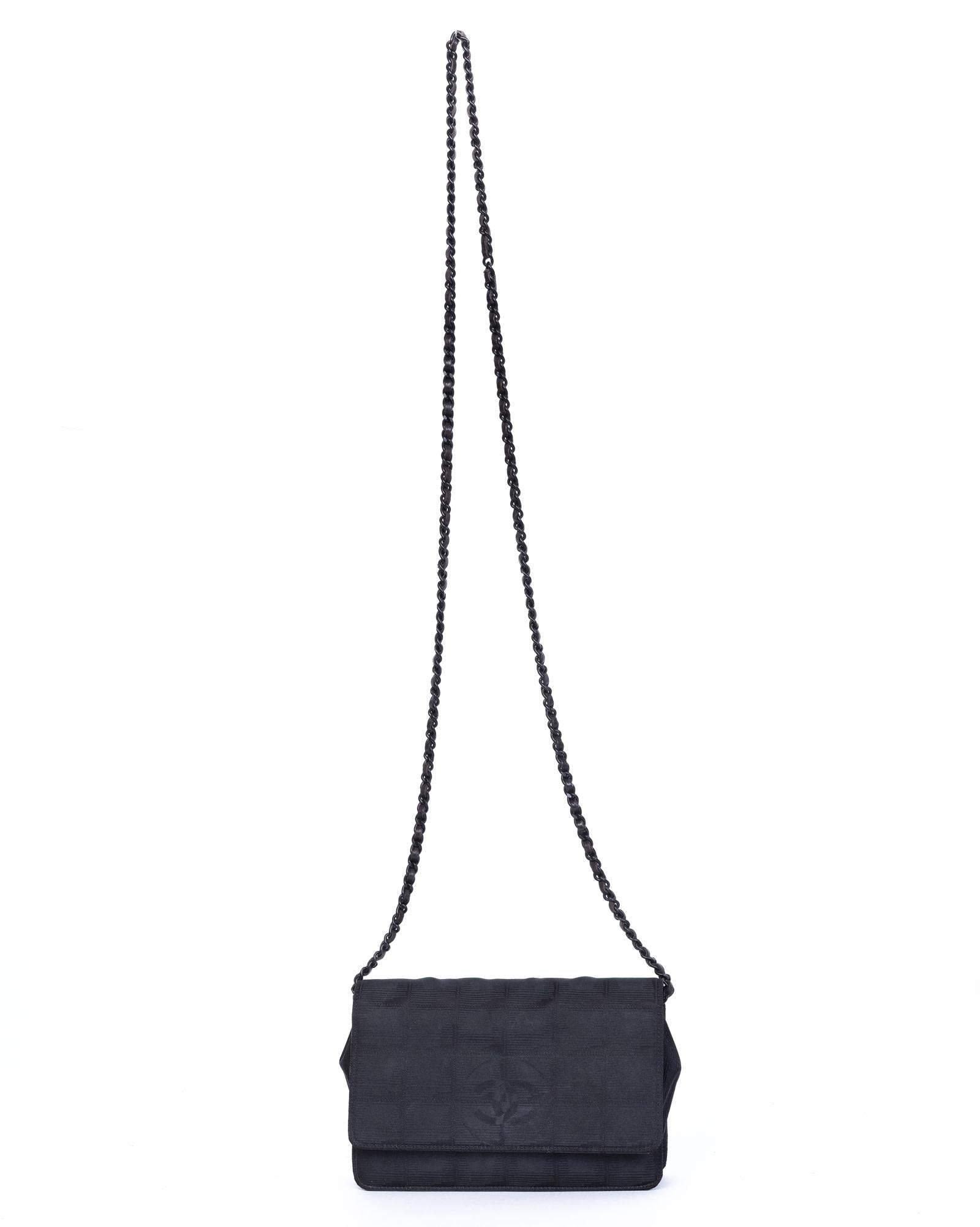 This Chanel Vintage Woc wallet on a chain shoulder bag is constructed in nylon and features three compartments and one compartment with a zipper closure, six card holders, a leather interior, and a black chain strap. (Chanel bags with the serial